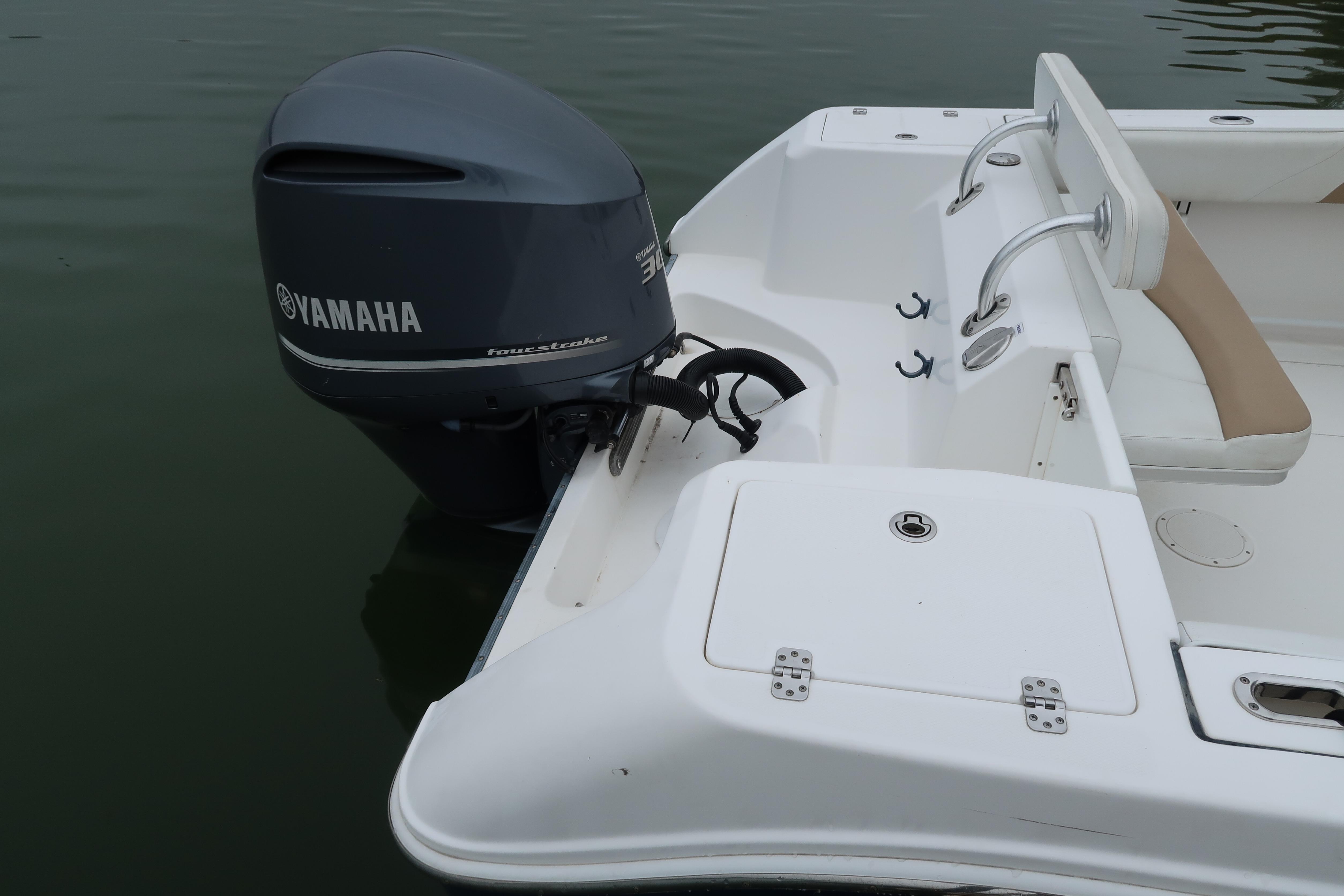2017 Edgewater 245CC boat with Yamaha outboard motor on calm water.