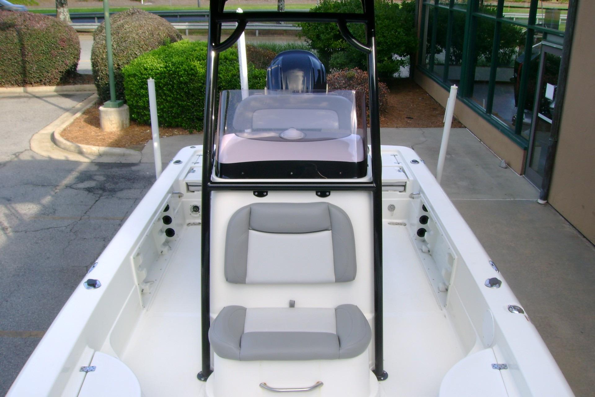 2022 NauticStar 227 XTS boat interior with seating and console, parked outdoors.