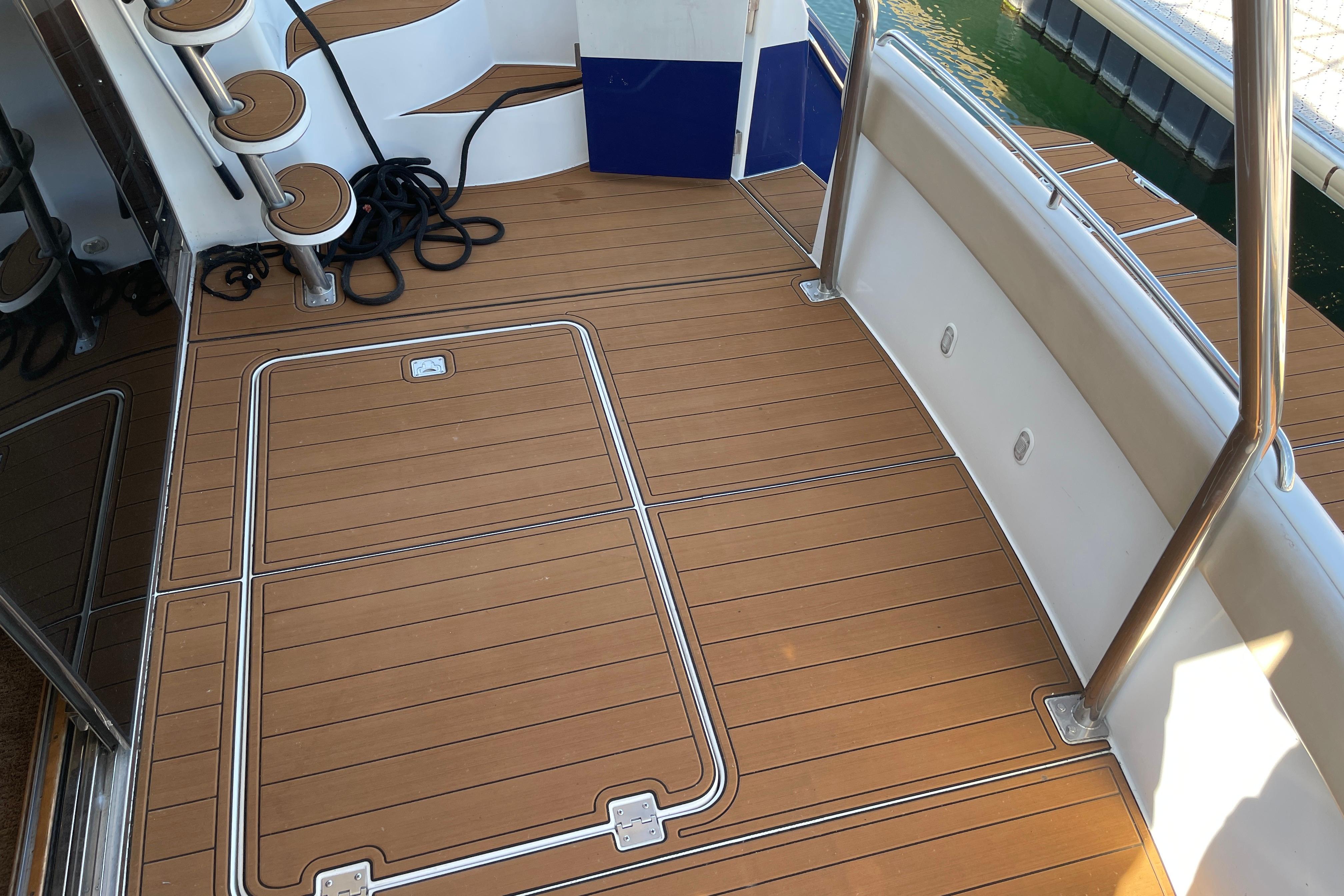 2002 Carver 570 Voyager Pilothouse deck with teak flooring and stainless steel railings.