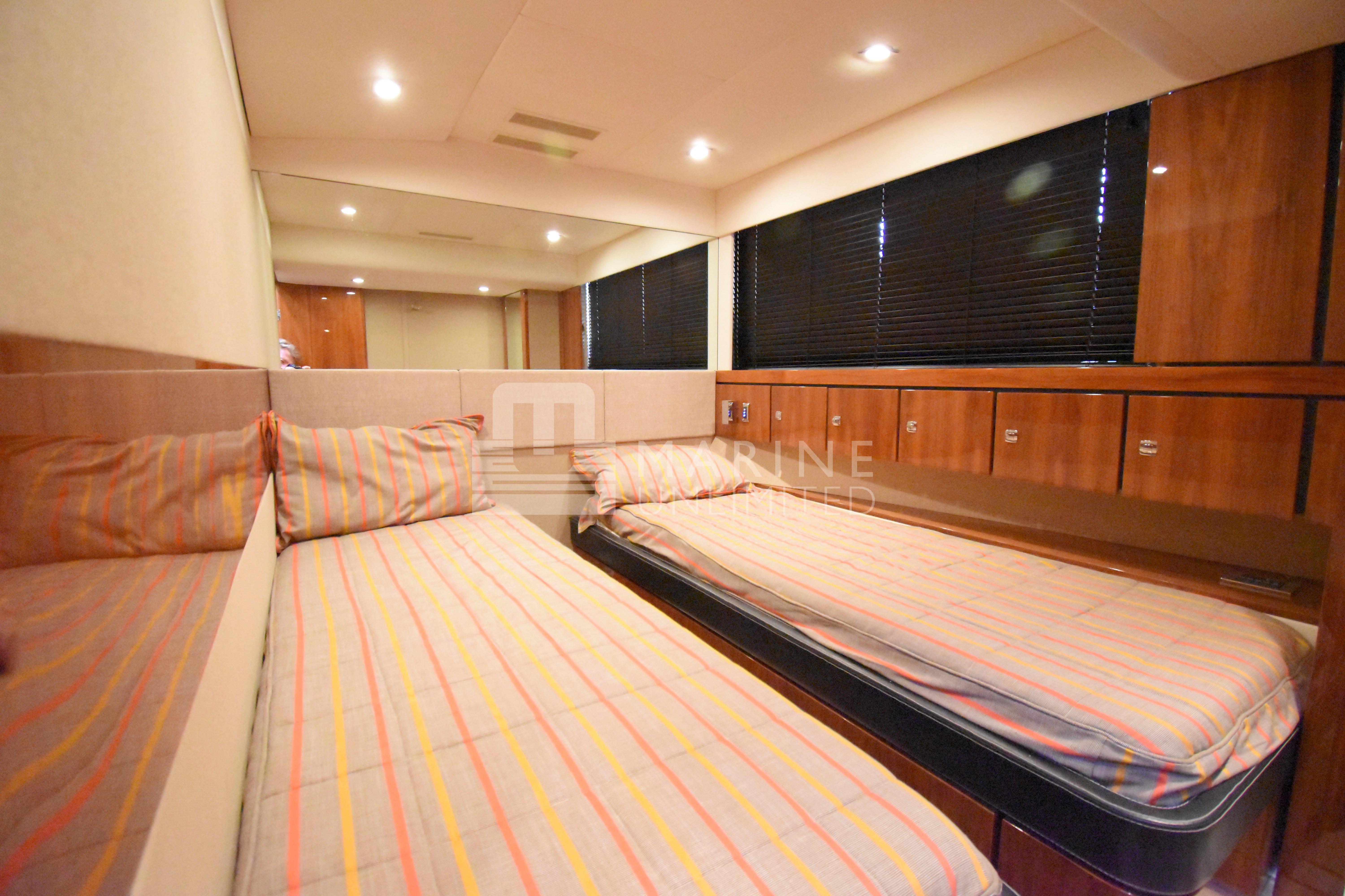 Luxurious cabin interior of 2010 Fairline Squadron 55 yacht with twin beds and wood paneling.