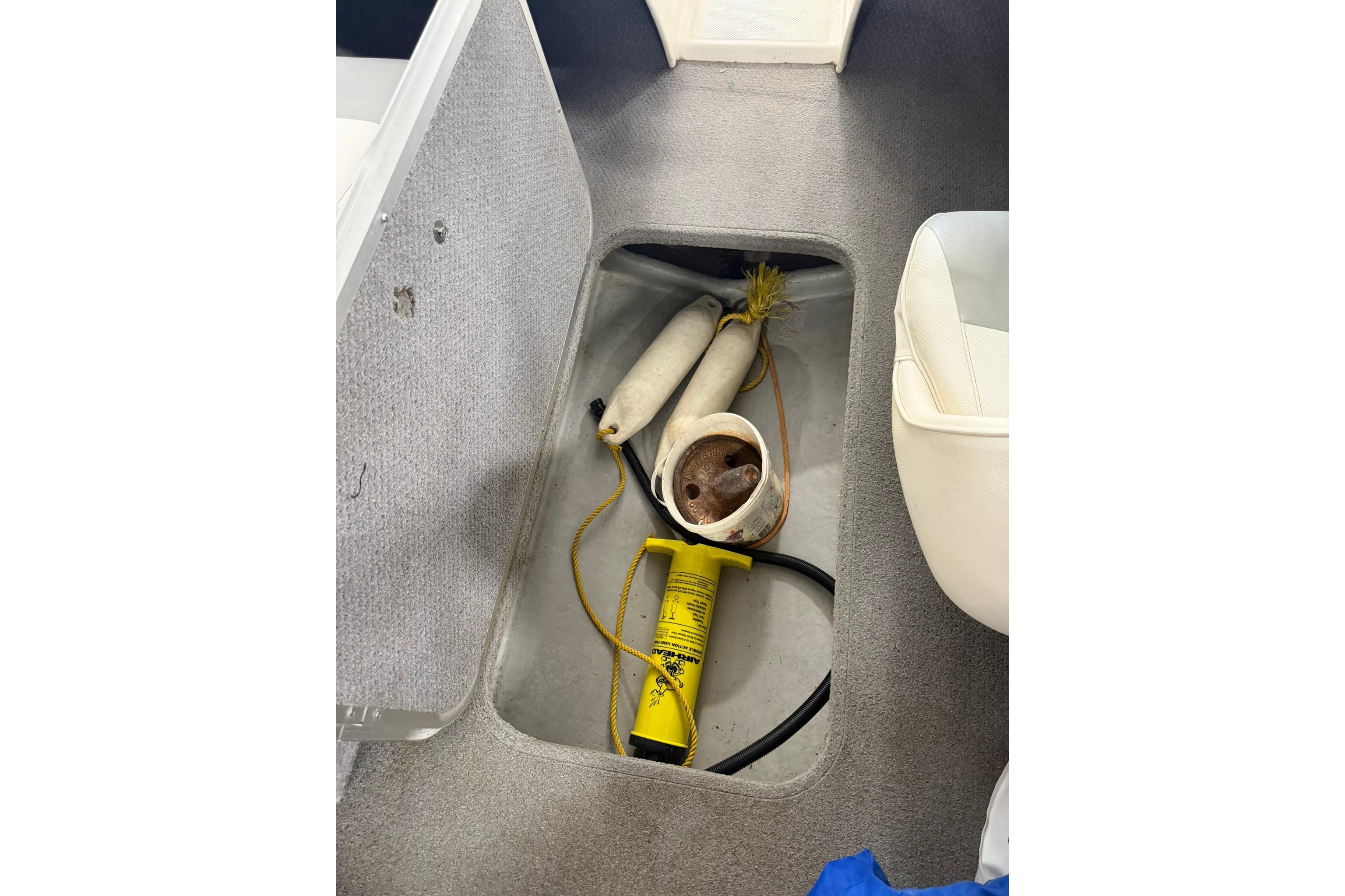 2012 Bayliner 175 Bowrider storage compartment with boating accessories and equipment.