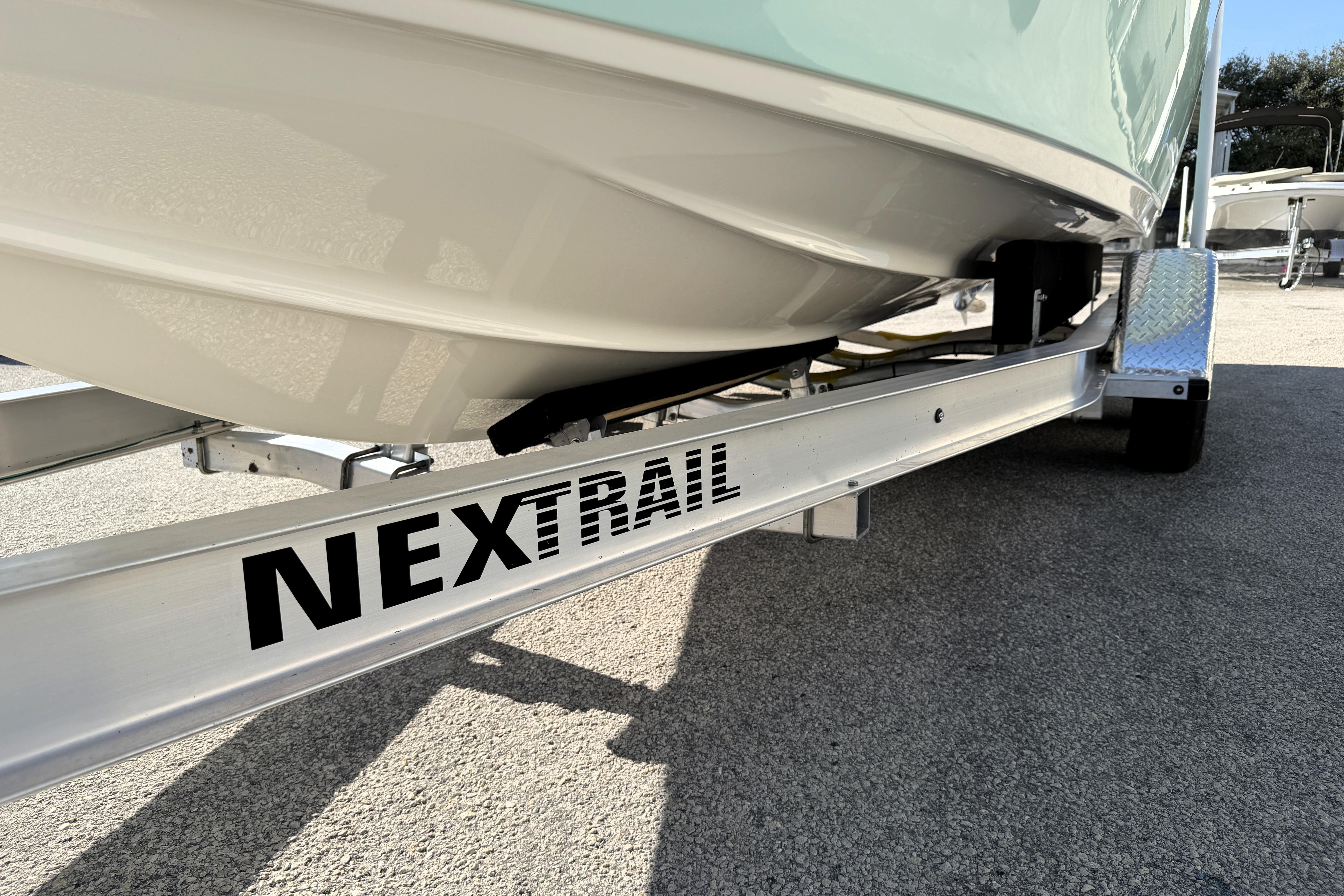 2025 Key West 239 FS boat on NexTrail trailer, close-up view.