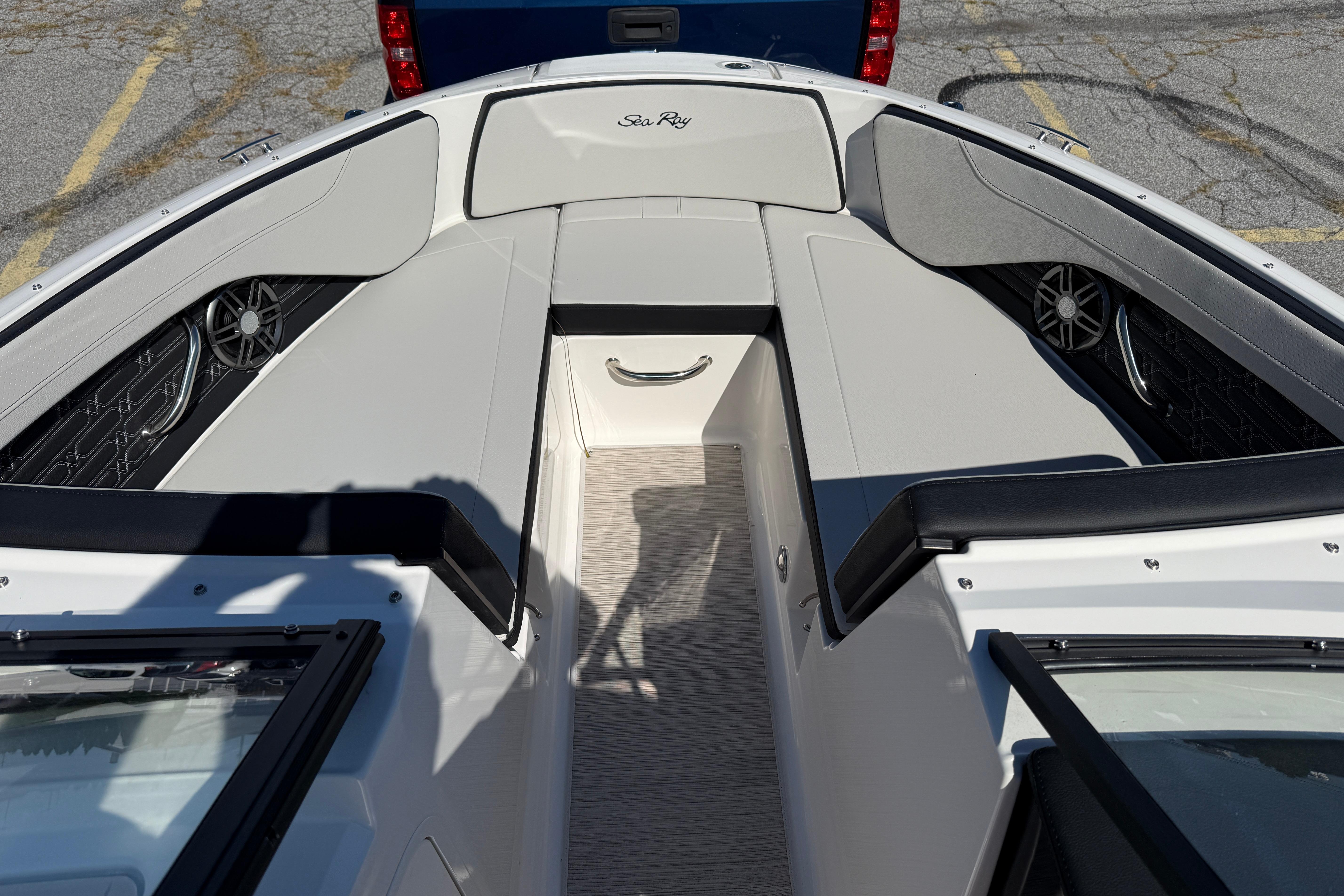 2026 Sea Ray SPX 210 boat interior with seating and speakers, parked on pavement.