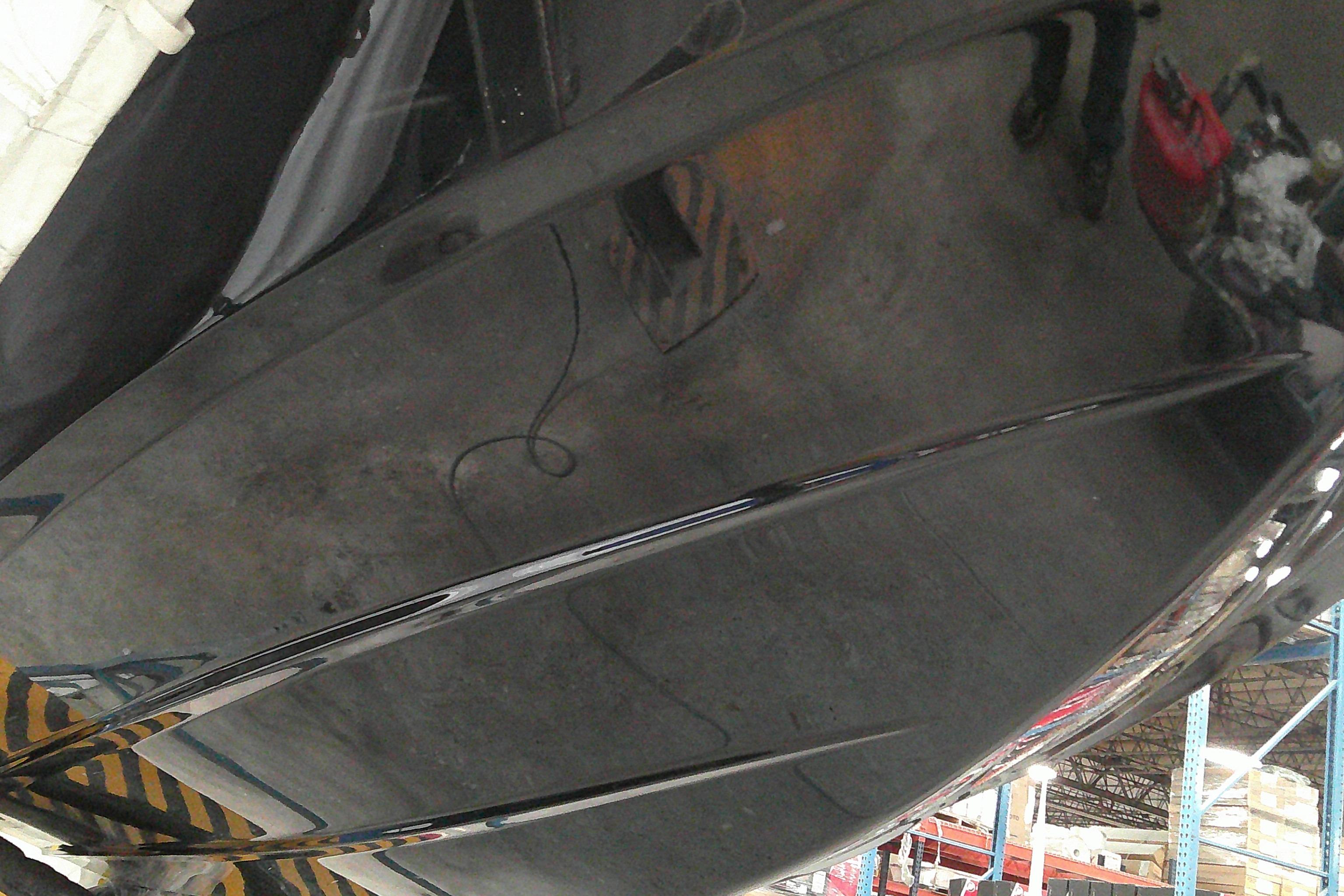 2025 Tahoe T18 boat hull in a warehouse setting, showcasing sleek design and glossy finish.