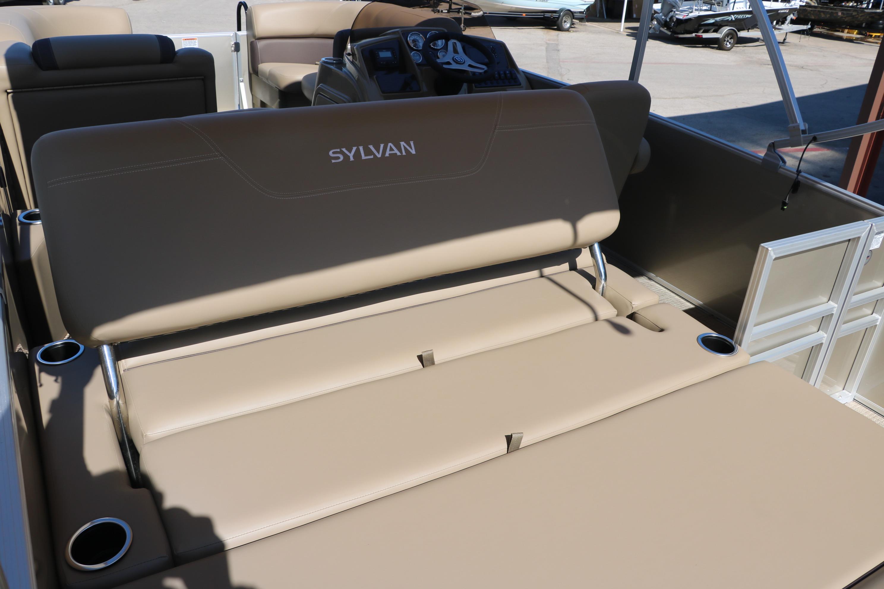 2025 Sylvan Mirage 820 CLZ DH boat interior with beige seating and cup holders.