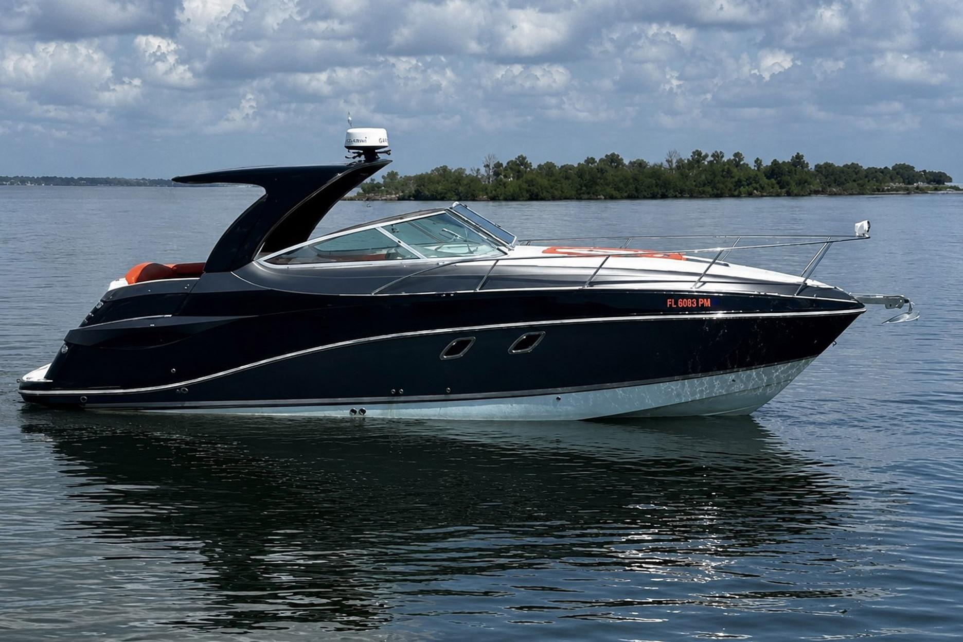 2012 Rinker 310 Express Cruiser LE on calm water under cloudy sky.