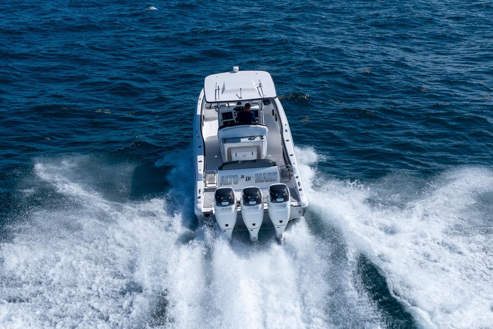 2019 Deep Impact 369 Sport boat cruising on open water, rear view.