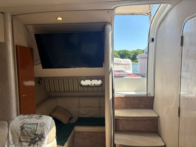 Interior of a 2002 Formula PC 37 with sofa and TV.