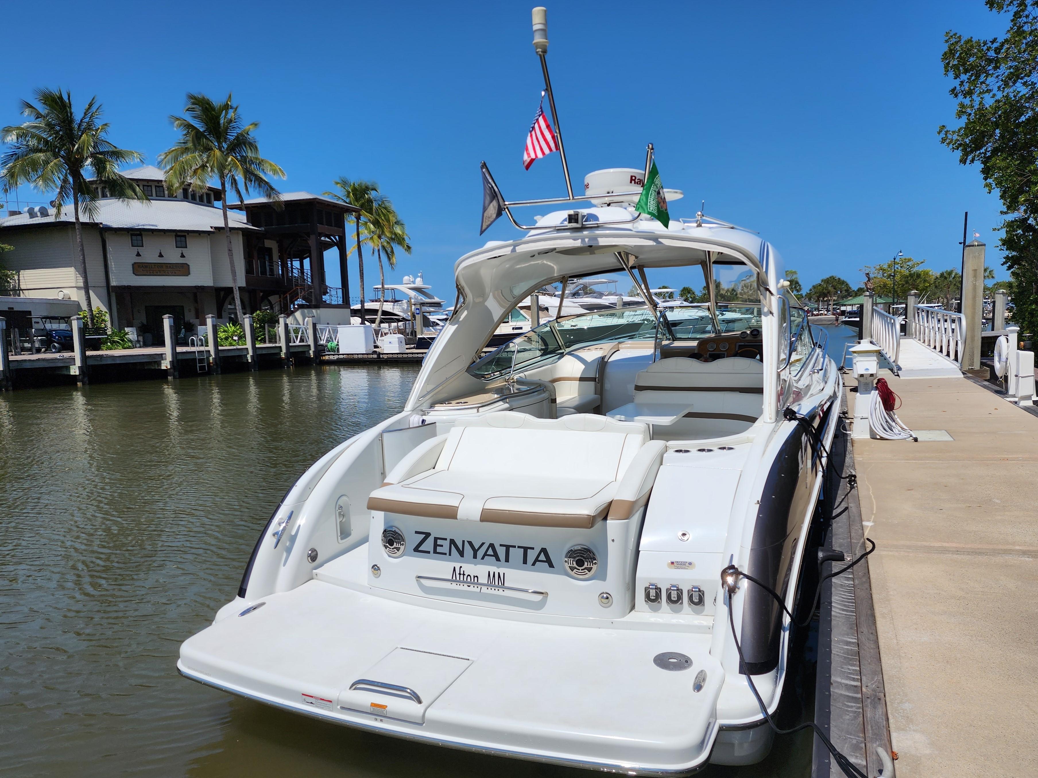 2012 Formula 400 Super Sport yacht docked at marina with palm trees.