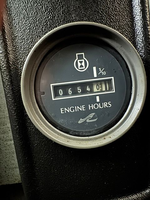 Close-up of an engine hour meter showing 654 hours on a 1992 Sea Ray 290 Sundancer.