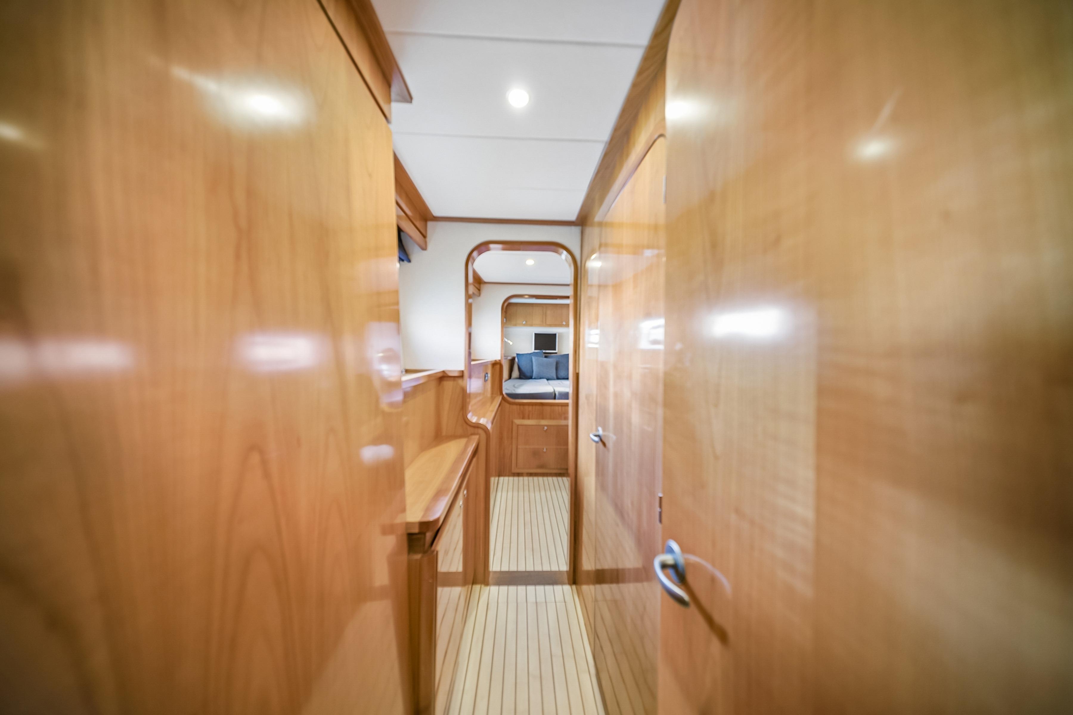 Luxurious wooden interior of a 2009 Catana 65 yacht, featuring sleek design and modern amenities.