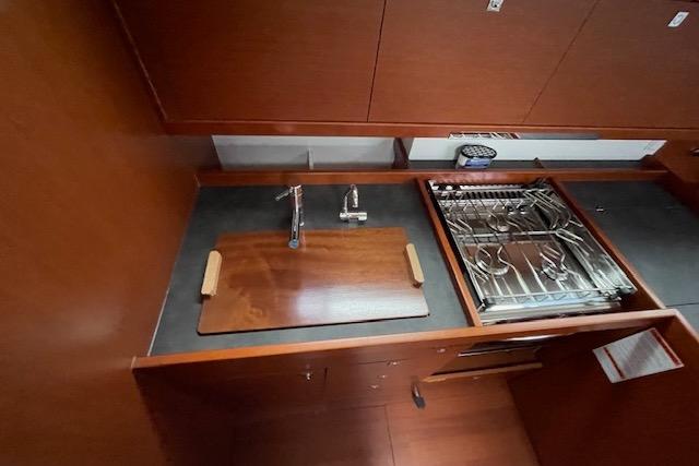 Galley kitchen in 2018 Beneteau Oceanis 45 yacht with stove and sink.