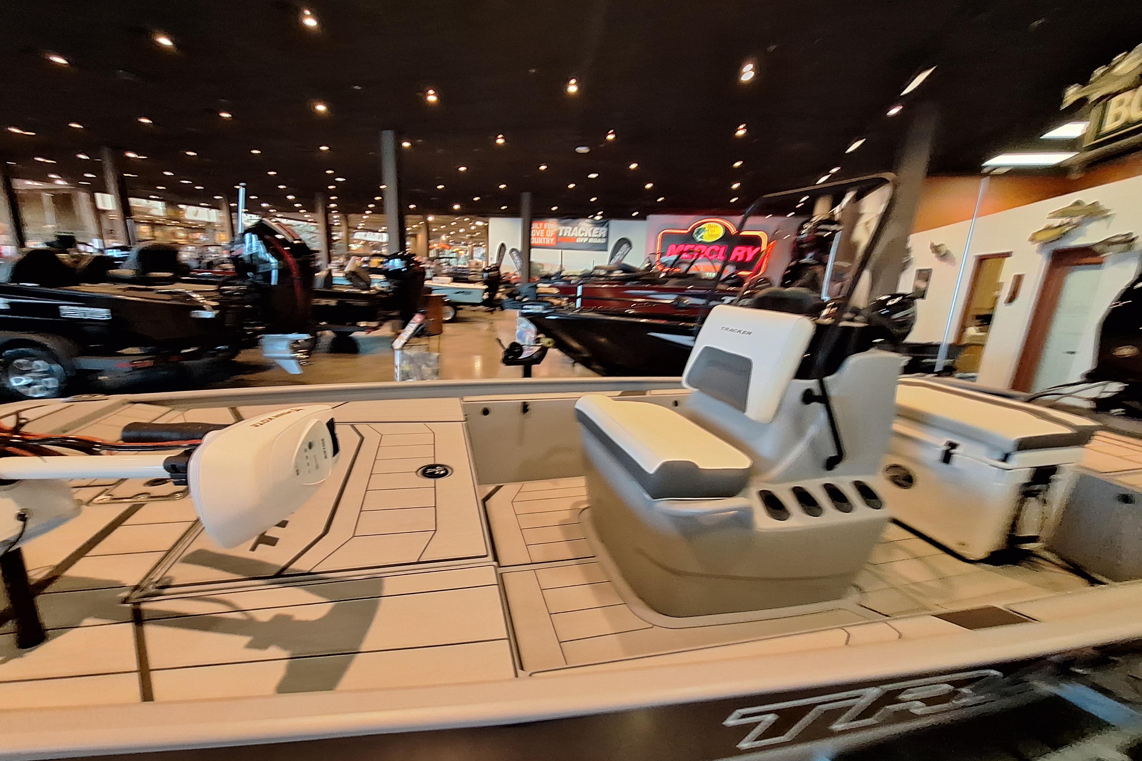 2026 Tracker Bass Tracker Classic CC boat displayed in a showroom with modern interior design.