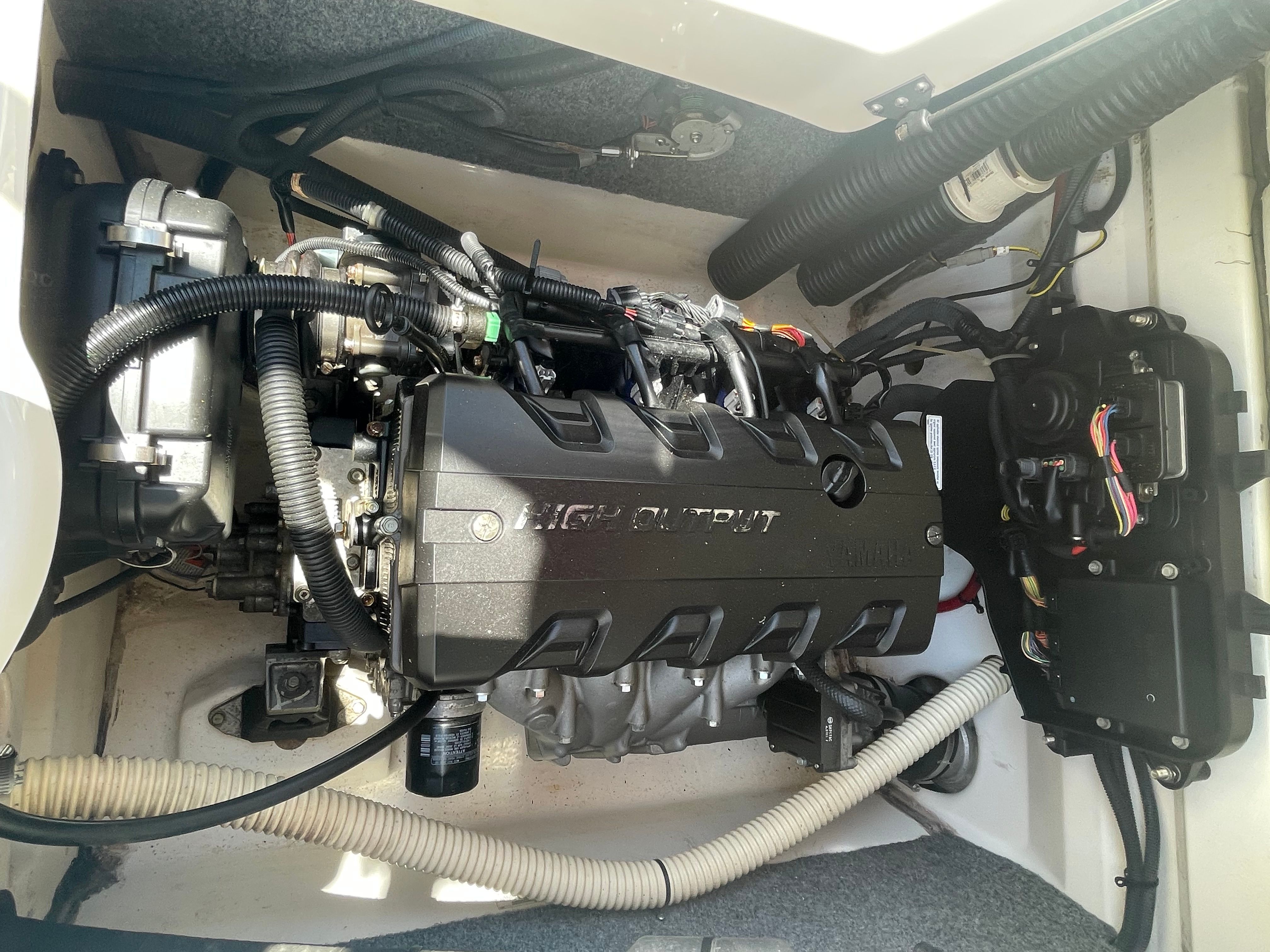 The engine compartment of a 2015 Yamaha SX190 shows a high-output engine with various hoses and cables.