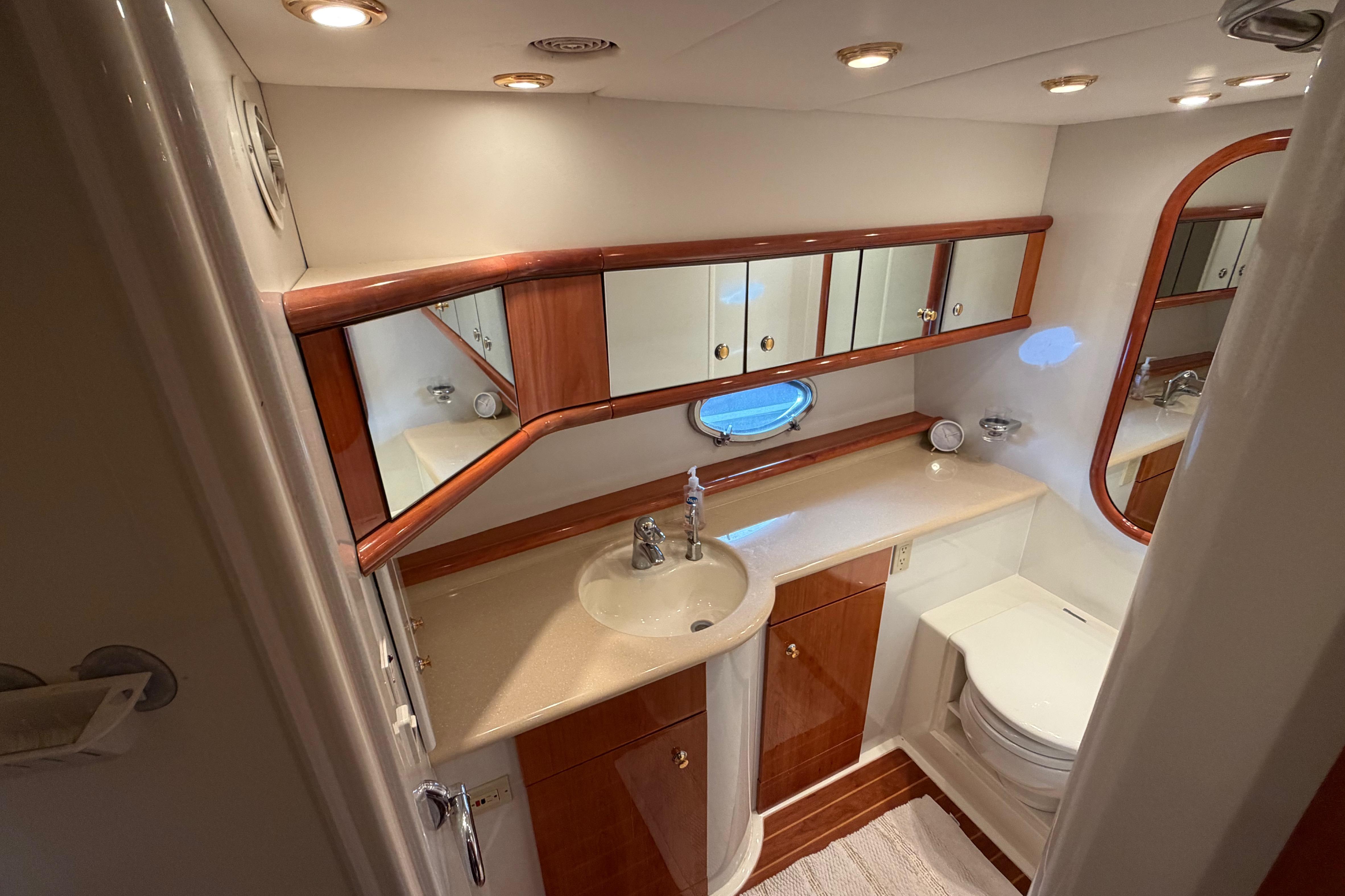 Luxurious bathroom in 2000 Sunseeker Manhattan 62 yacht with elegant wood accents.