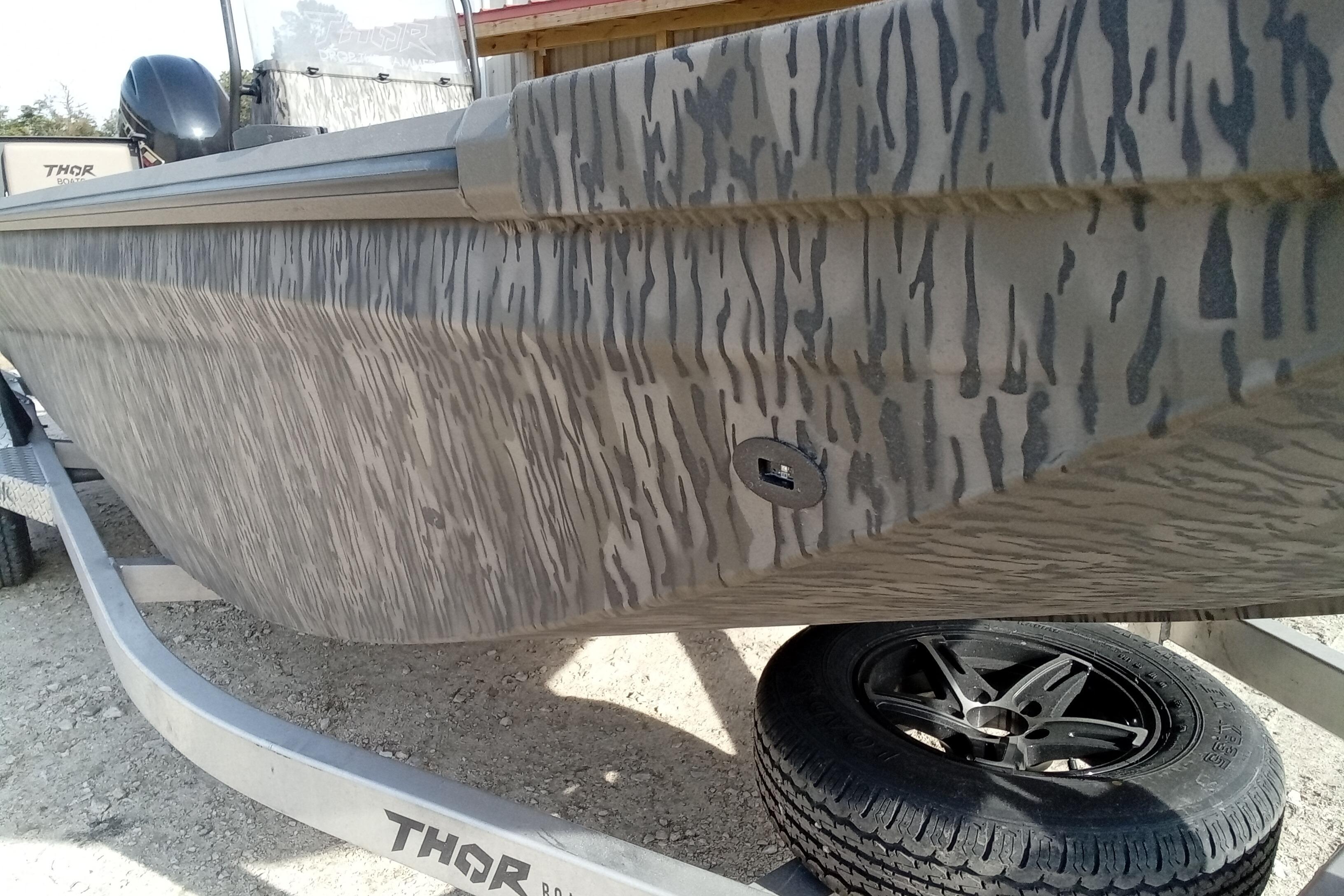 2026 Thor 1900 Low Country Elite boat with camouflage pattern on trailer.
