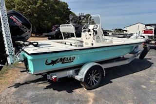 2025 Mako 18 LTS boat on trailer, parked outdoors, featuring a sleek design and modern outboard motor.