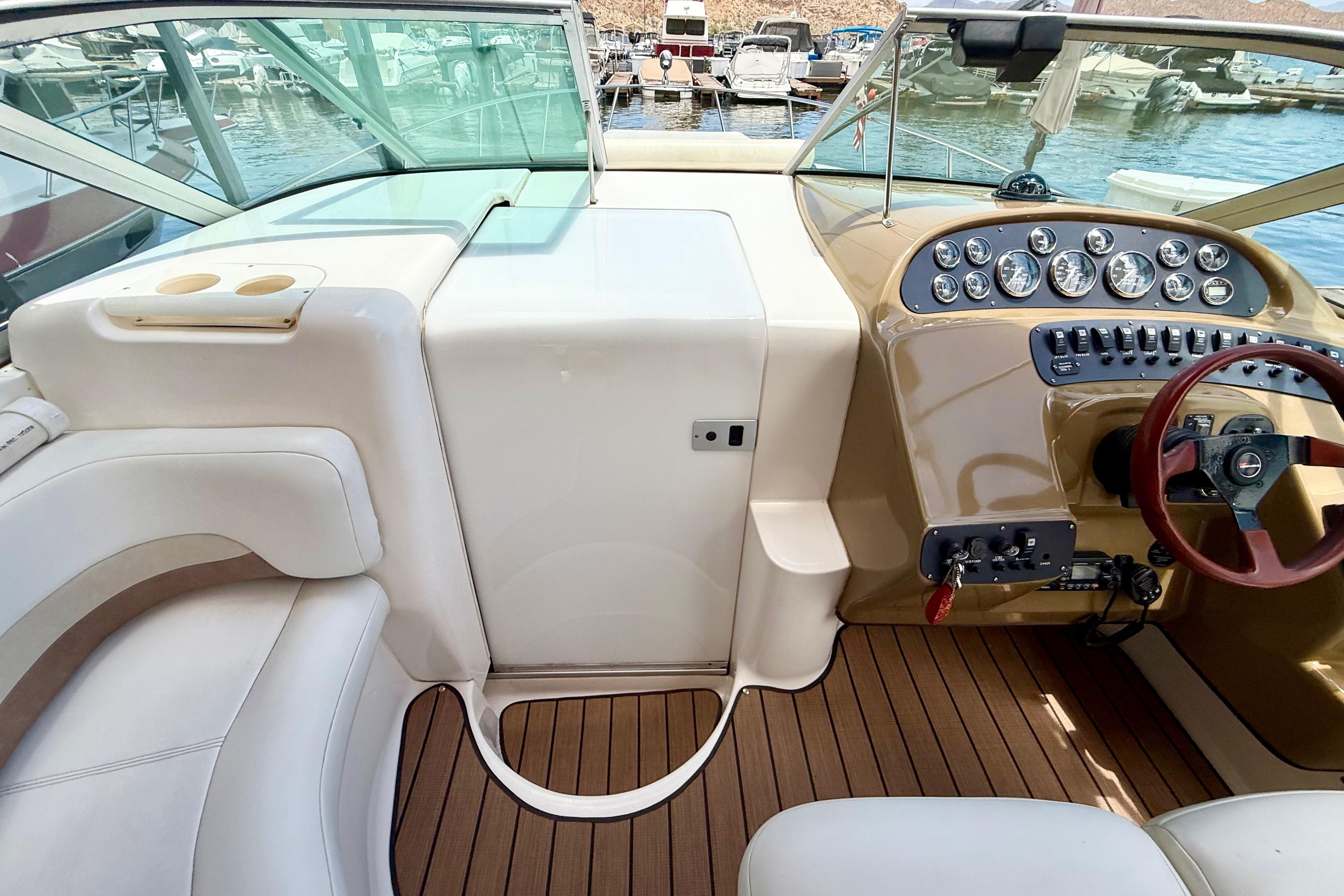 1999 Chaparral Signature 300 boat cockpit with steering wheel, gauges, and seating.