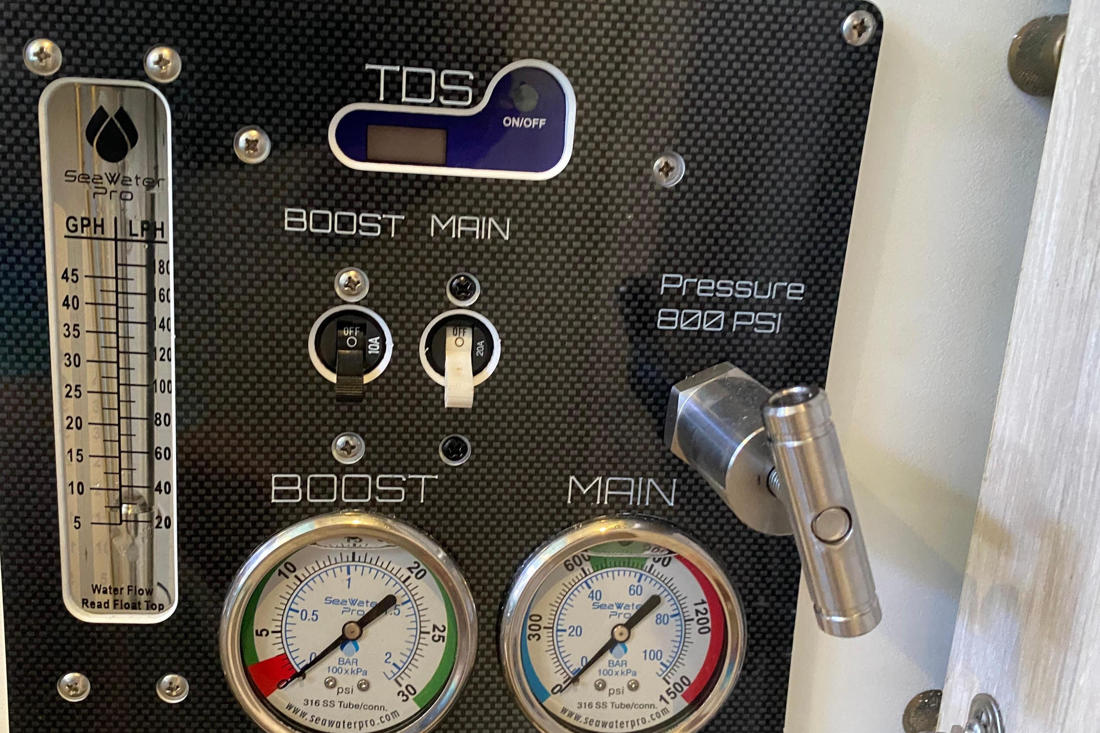 Control panel of a 2017 Leopard 40 with pressure gauges and flow meter.