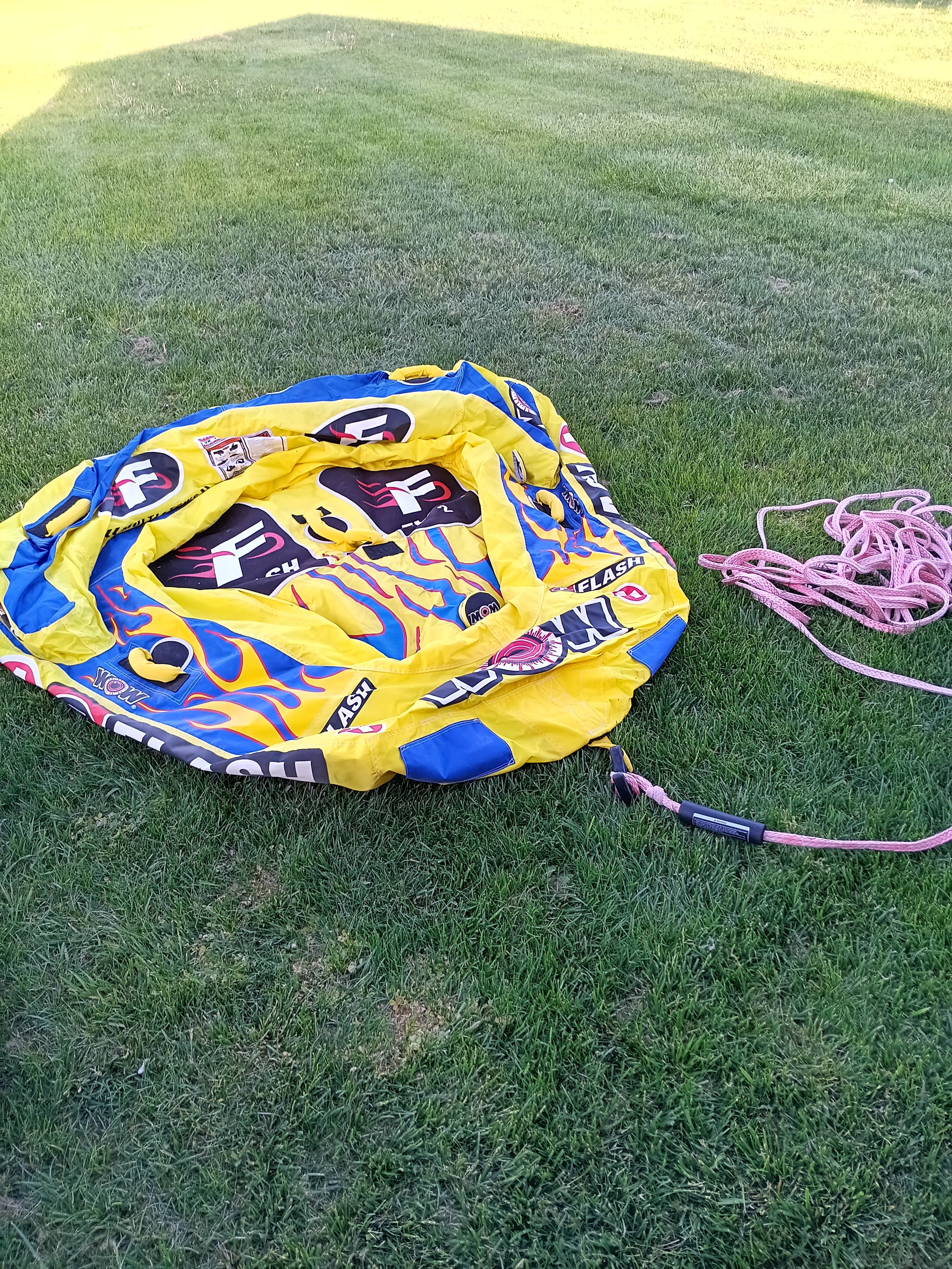 Inflatable water tube with rope on grass, Malibu Skier 1991.