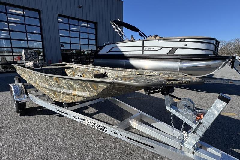 2026 War Eagle 648LDV boat on trailer, parked outside dealership.