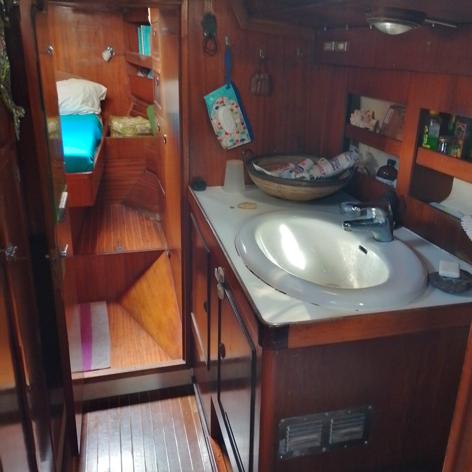 Interior of 1983 Franchini 47 yacht with wooden cabinetry and compact sink area.
