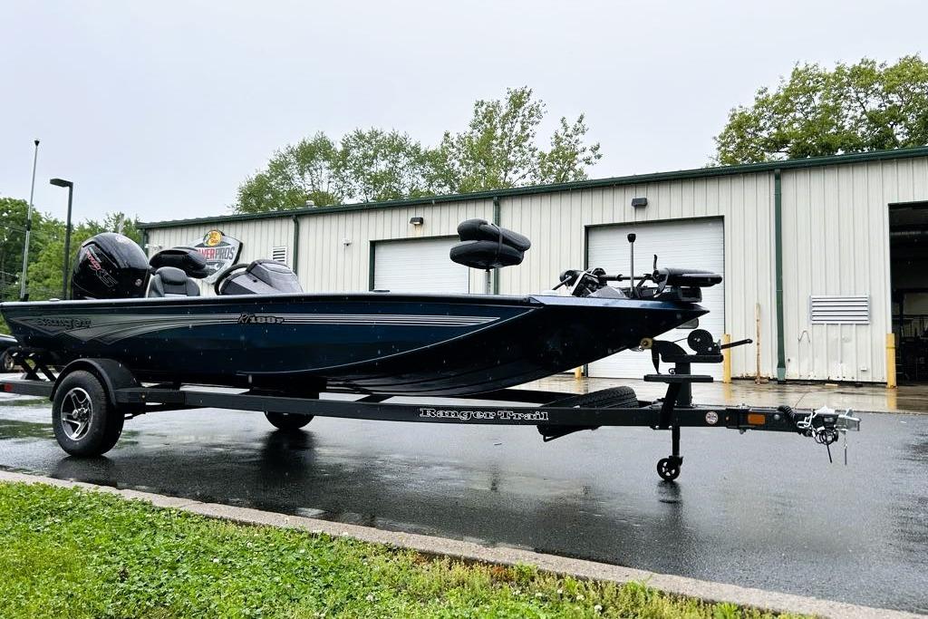 2026 Ranger RT188P boat on trailer outside a garage on a rainy day.