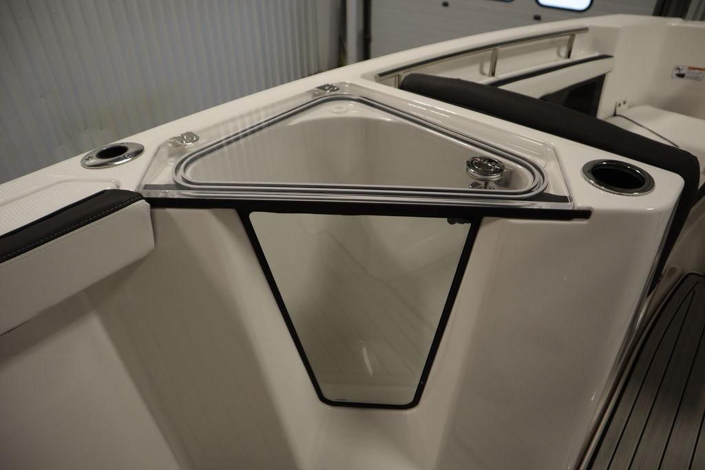 2026 Yamaha Boats 255 FSH Sport E interior detail with storage compartment and cup holders.