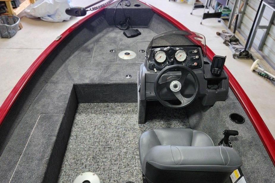 2026 Tracker Super Guide V-16 SC boat interior with steering console and seating.