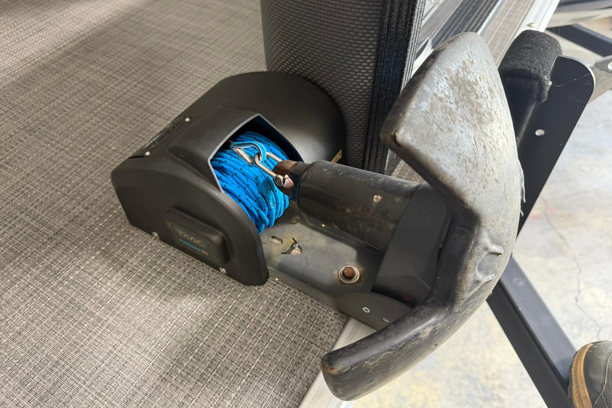2023 Crest Classic LX 200 anchor winch with blue rope on textured surface.