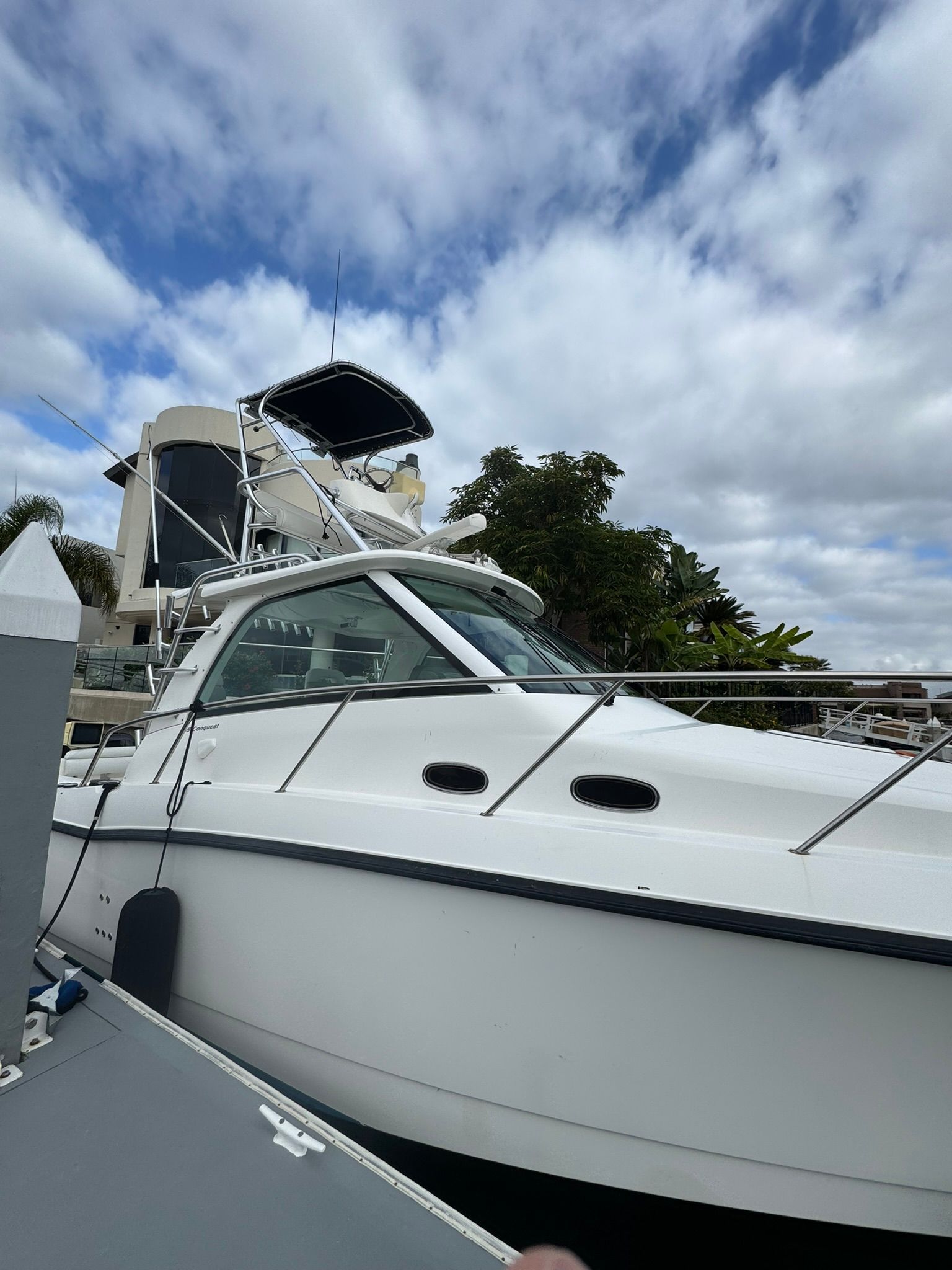 A 2008 Boston Whaler 345 Conquest is docked. The sky is cloudy.