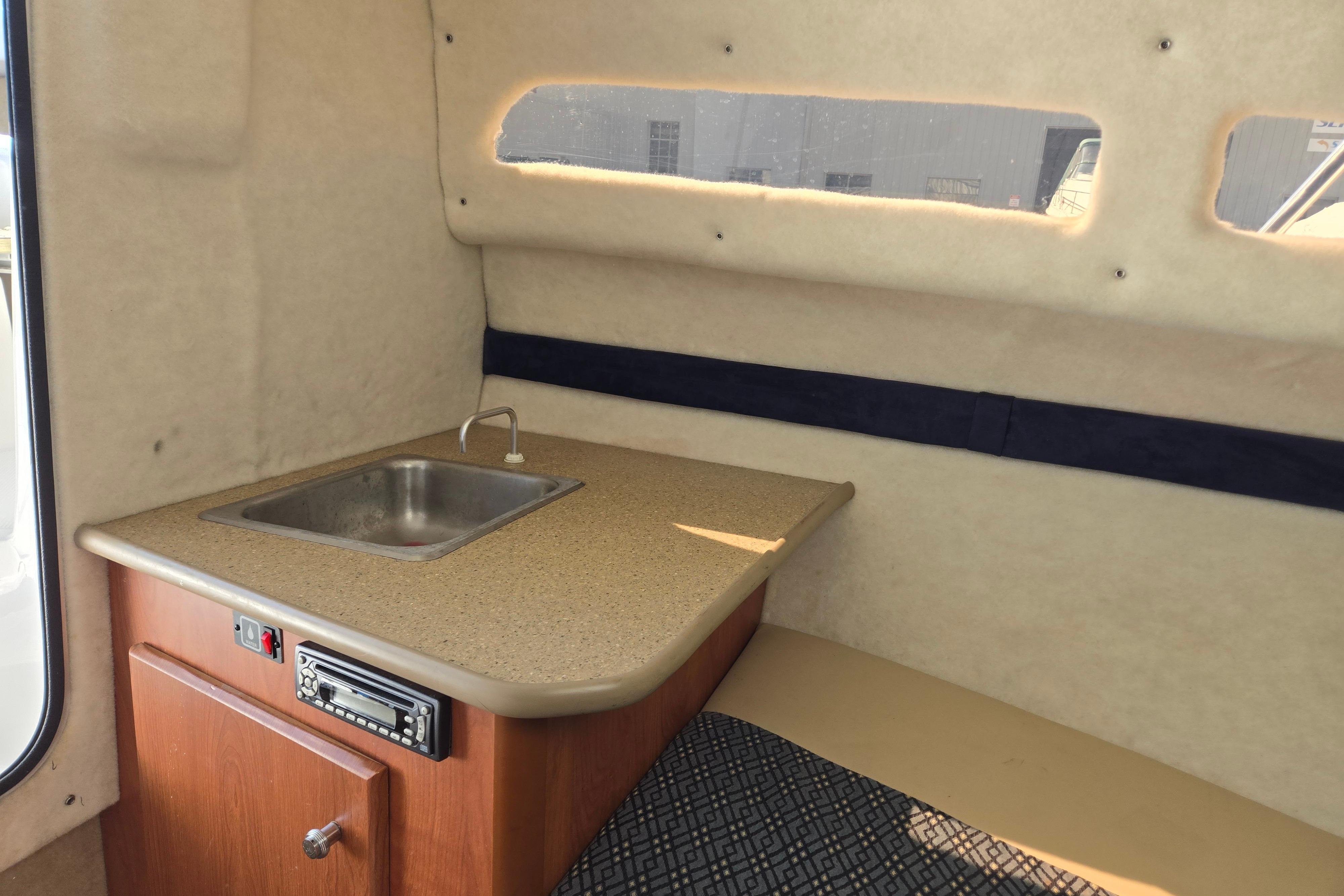 2006 Bayliner 222 Classic boat interior with kitchenette and sink.