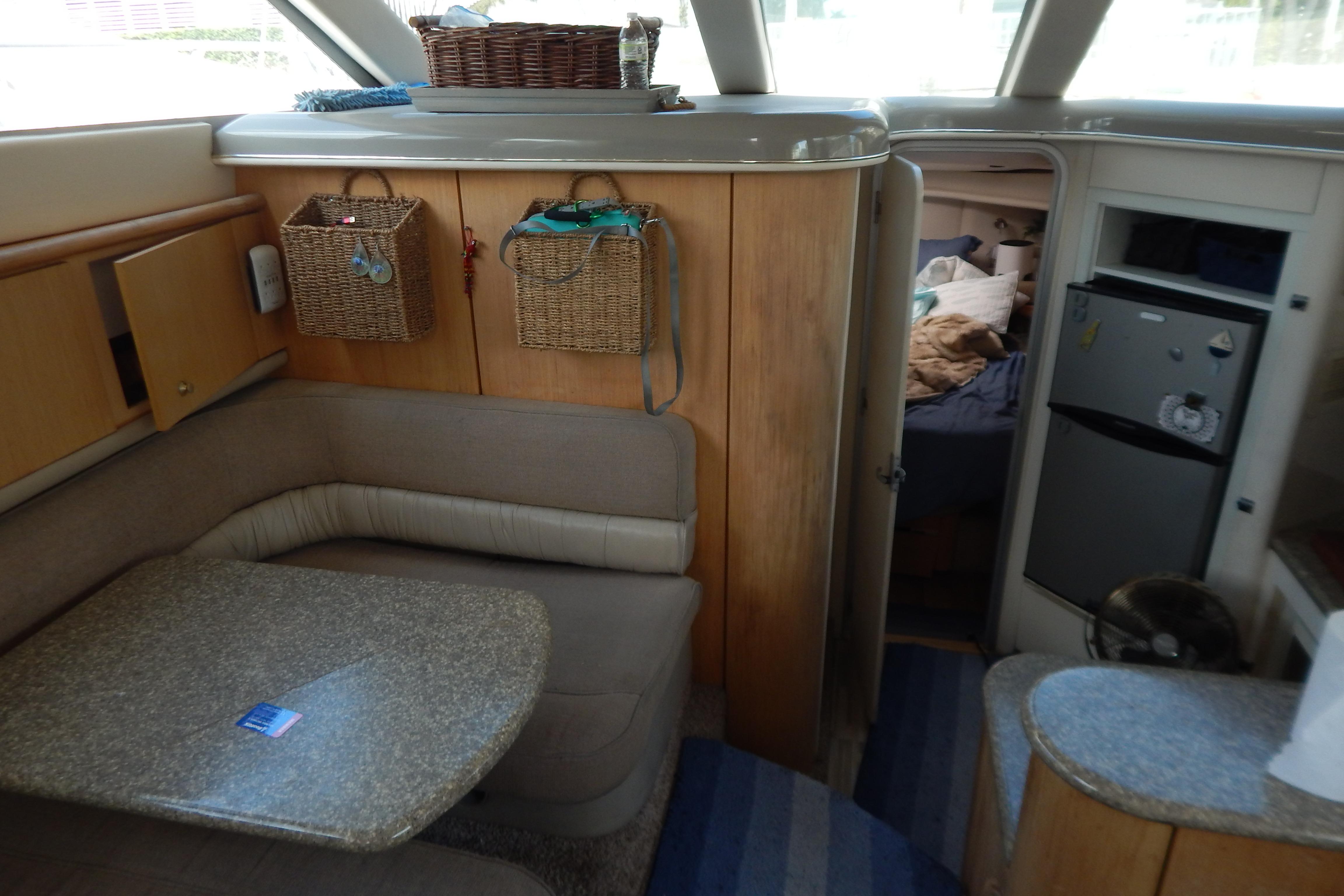 Interior of 1998 Magnum 4100 SCR yacht with cozy seating and kitchenette.