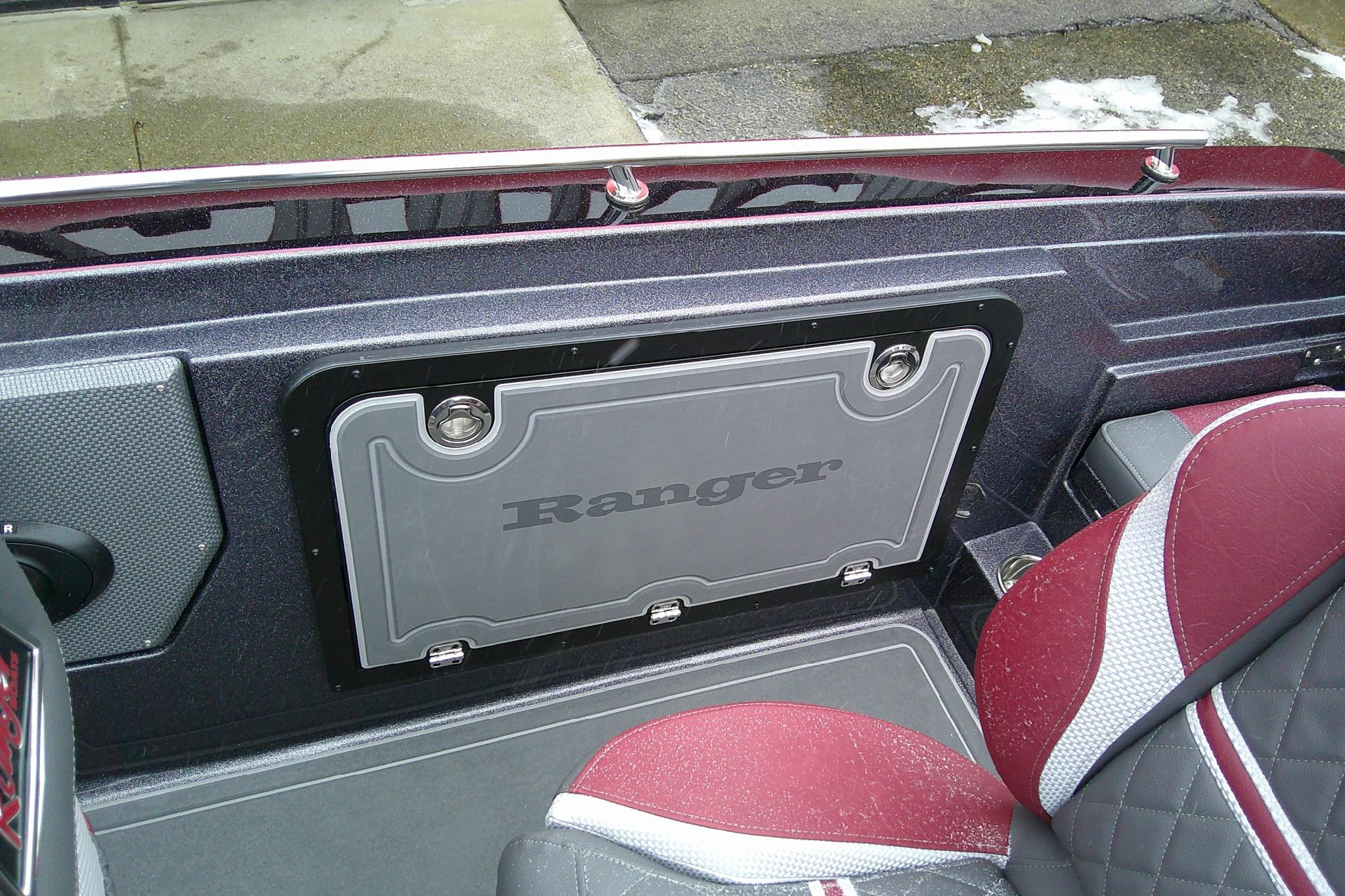 2026 Ranger 620xFS Pro boat interior with red and gray seating and storage compartment.