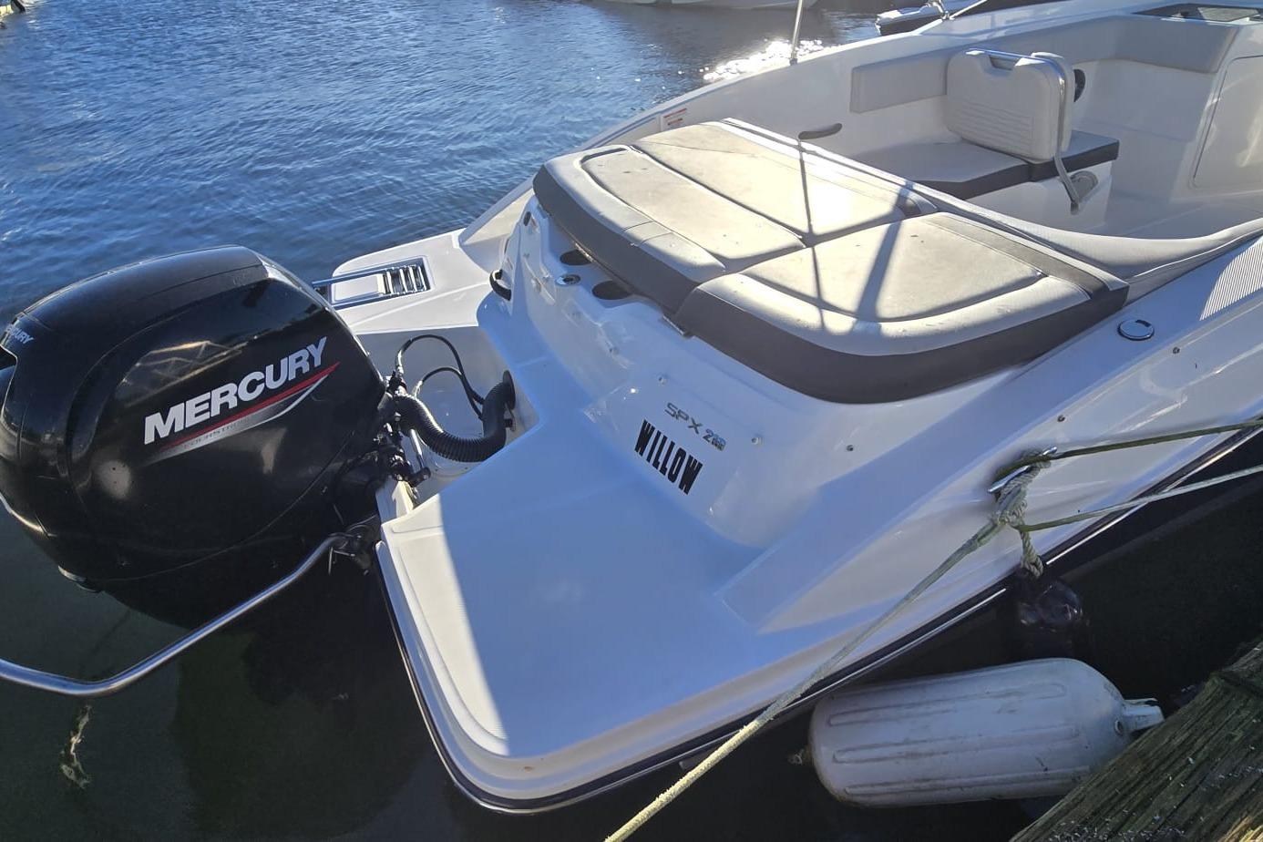 2023 Sea Ray SPX 210 Outboard boat with Mercury engine docked on water.