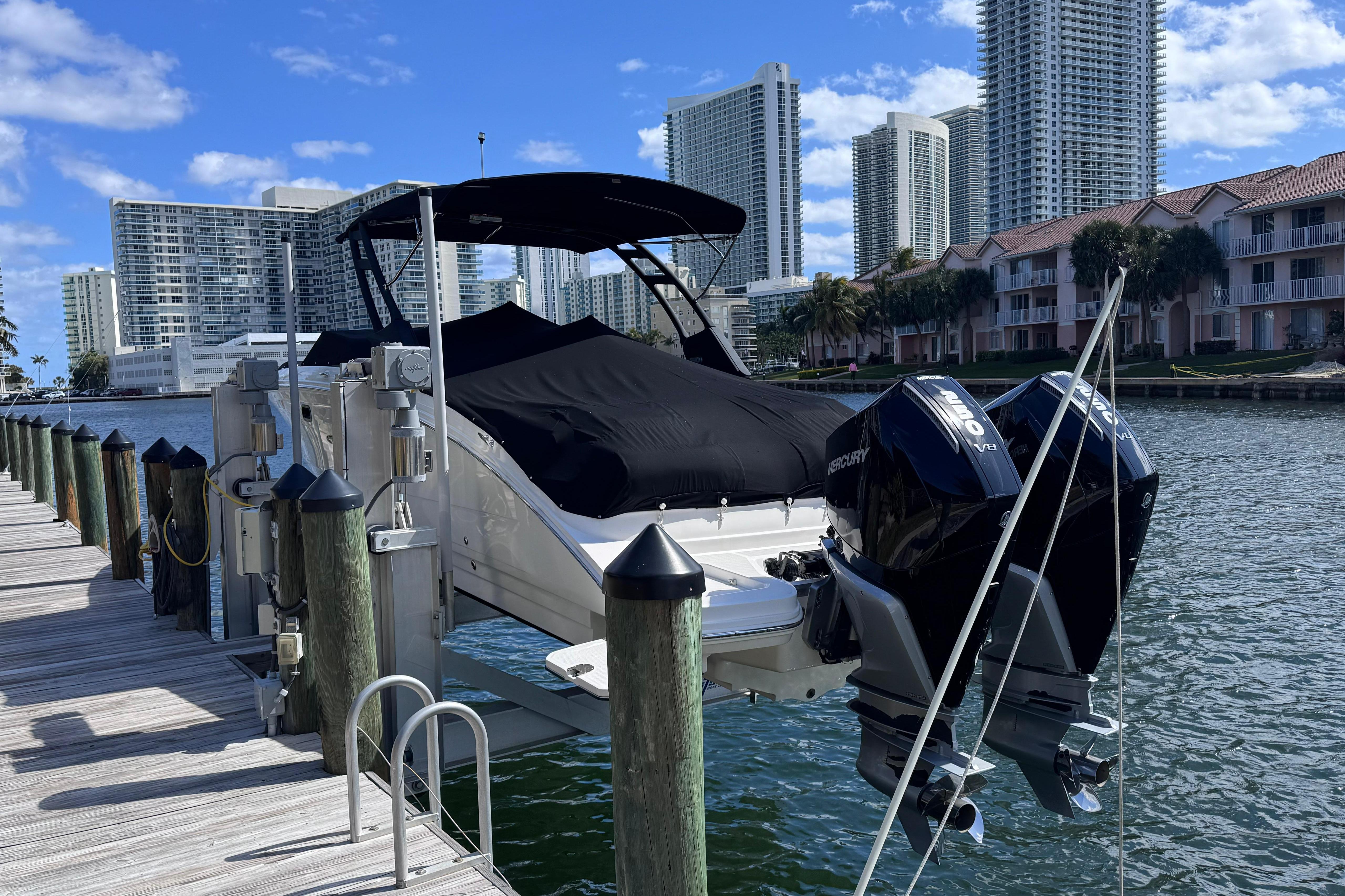 2024 Sea Ray SDX 290 Outboard docked with cityscape background.