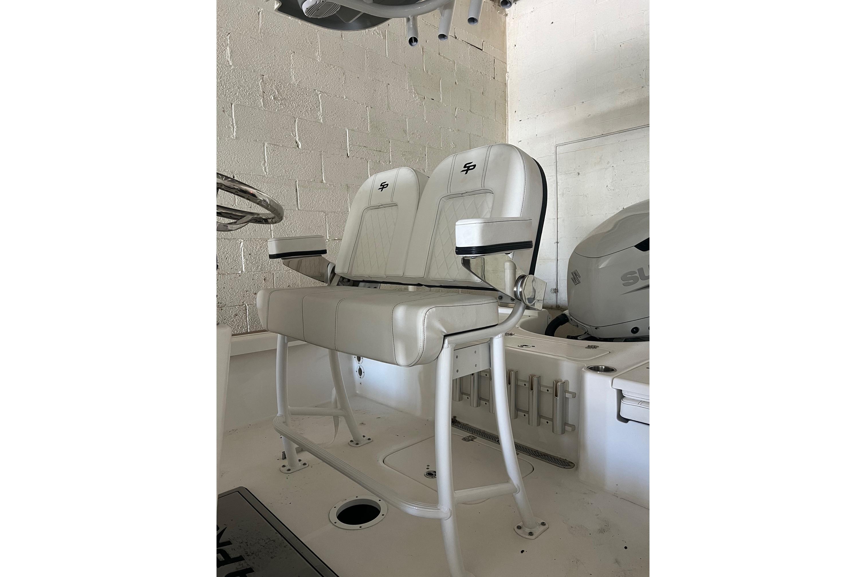 2024 Sea Pro 230 Bay boat seating with white cushioned seats and armrests.