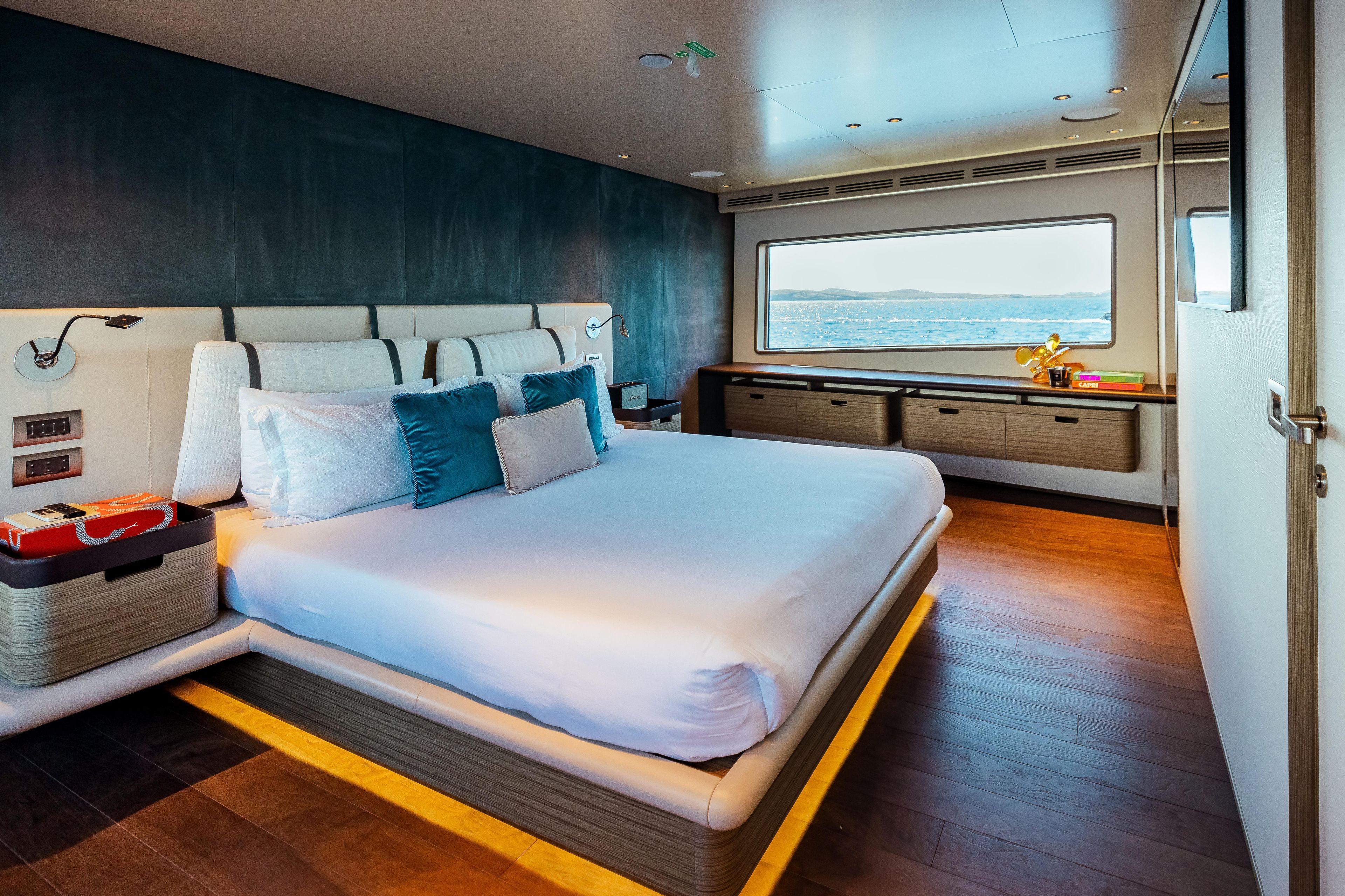 Luxurious bedroom interior of 2022 Custom Line Navetta 30 yacht with ocean view.