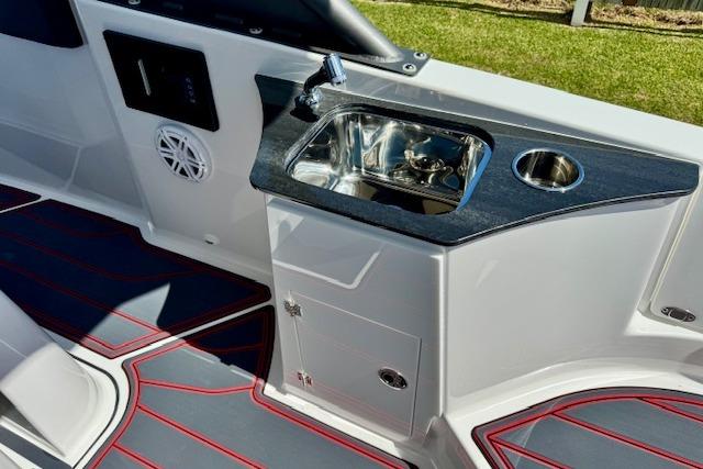 2026 Monterey Elite 25 OB boat interior with sink and modern design.