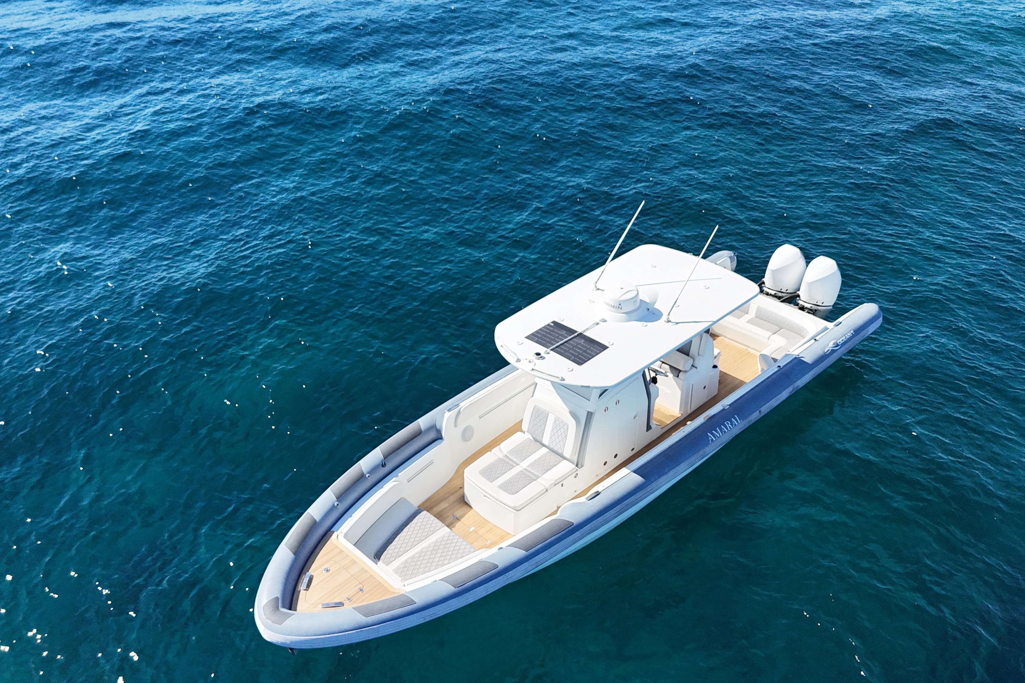 Aerial view of 2022 Ocean 1 model 370 boat on clear blue water.