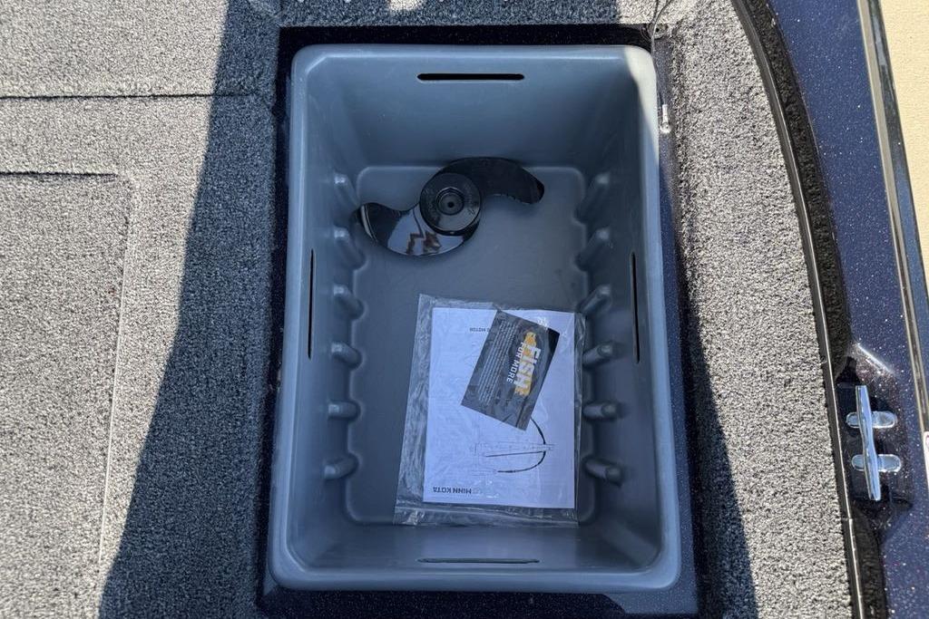 Storage compartment in 2026 Nitro Z17 boat with propeller and manual.
