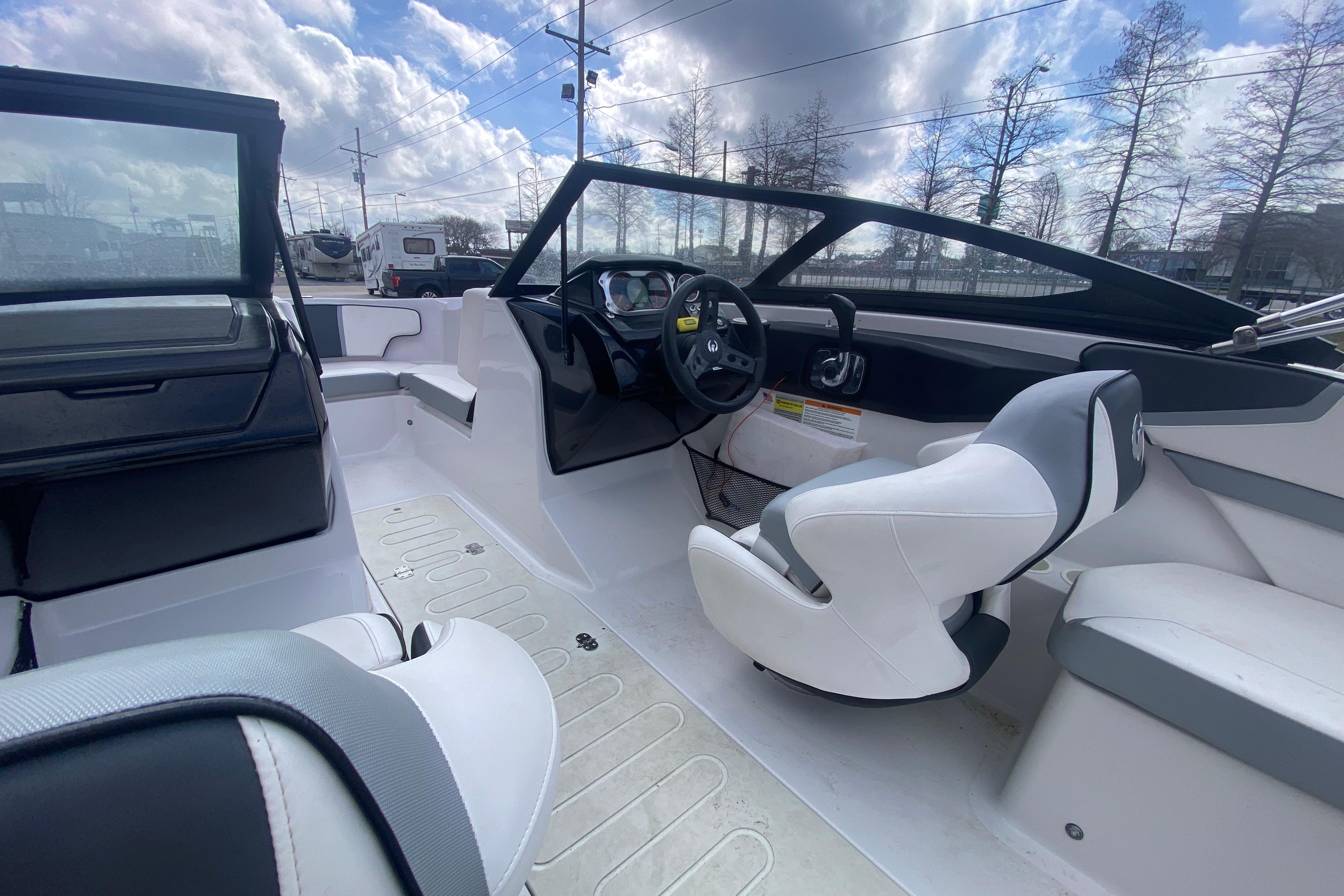 Interior of a 2018 Scarab 215 G boat with modern seating and steering wheel.