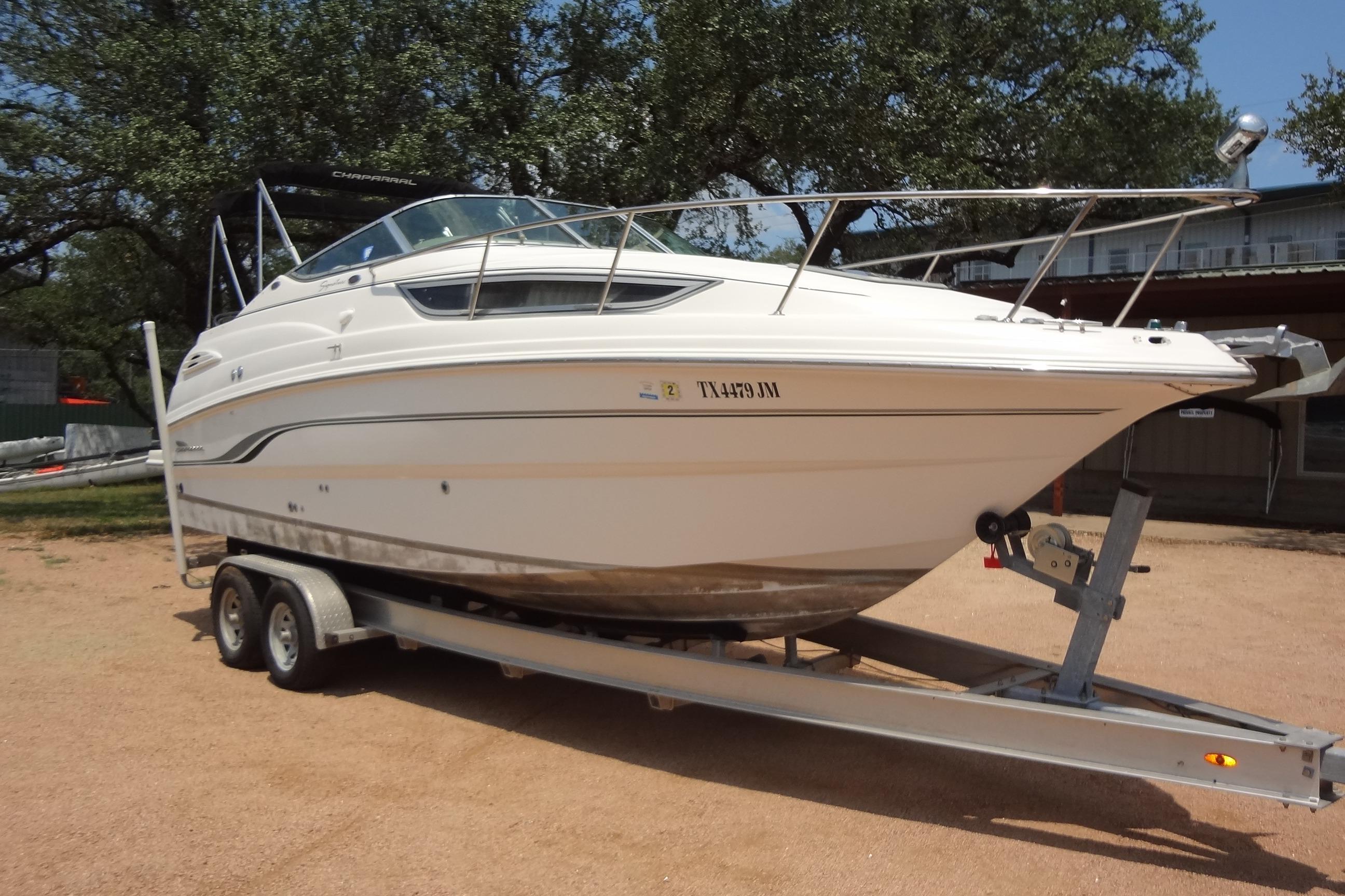 2000 Chaparral Signature 260 boat on trailer, parked outdoors.