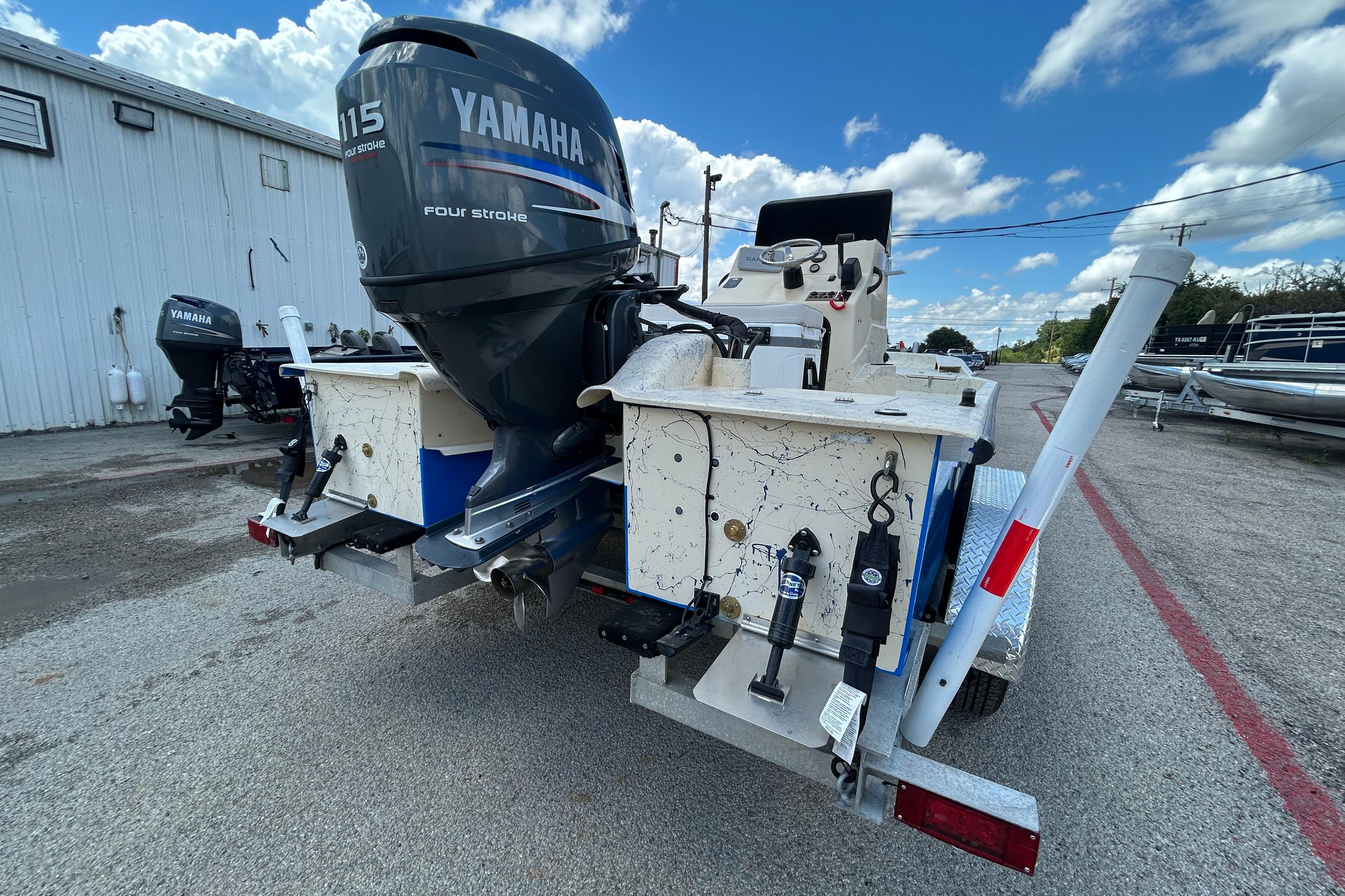 2007 Flats Cat 19 boat with Yamaha 115 four-stroke engine, parked outdoors.