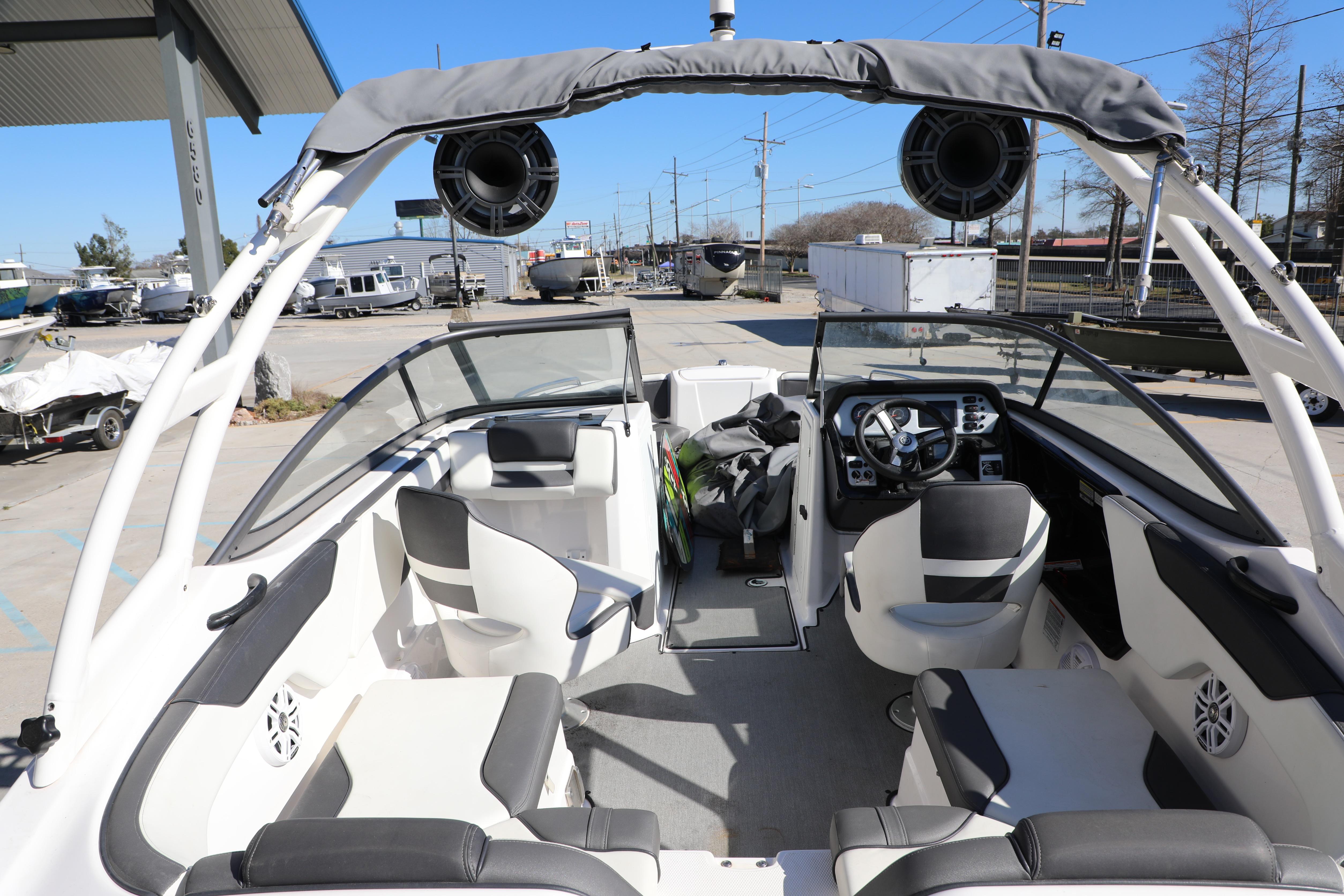 2022 Yamaha Boats AR210 interior with seating and dashboard, parked outdoors.