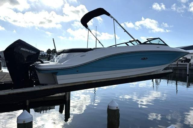 2022 Sea Ray SPX 210 Outboard boat docked, featuring sleek design and blue hull.