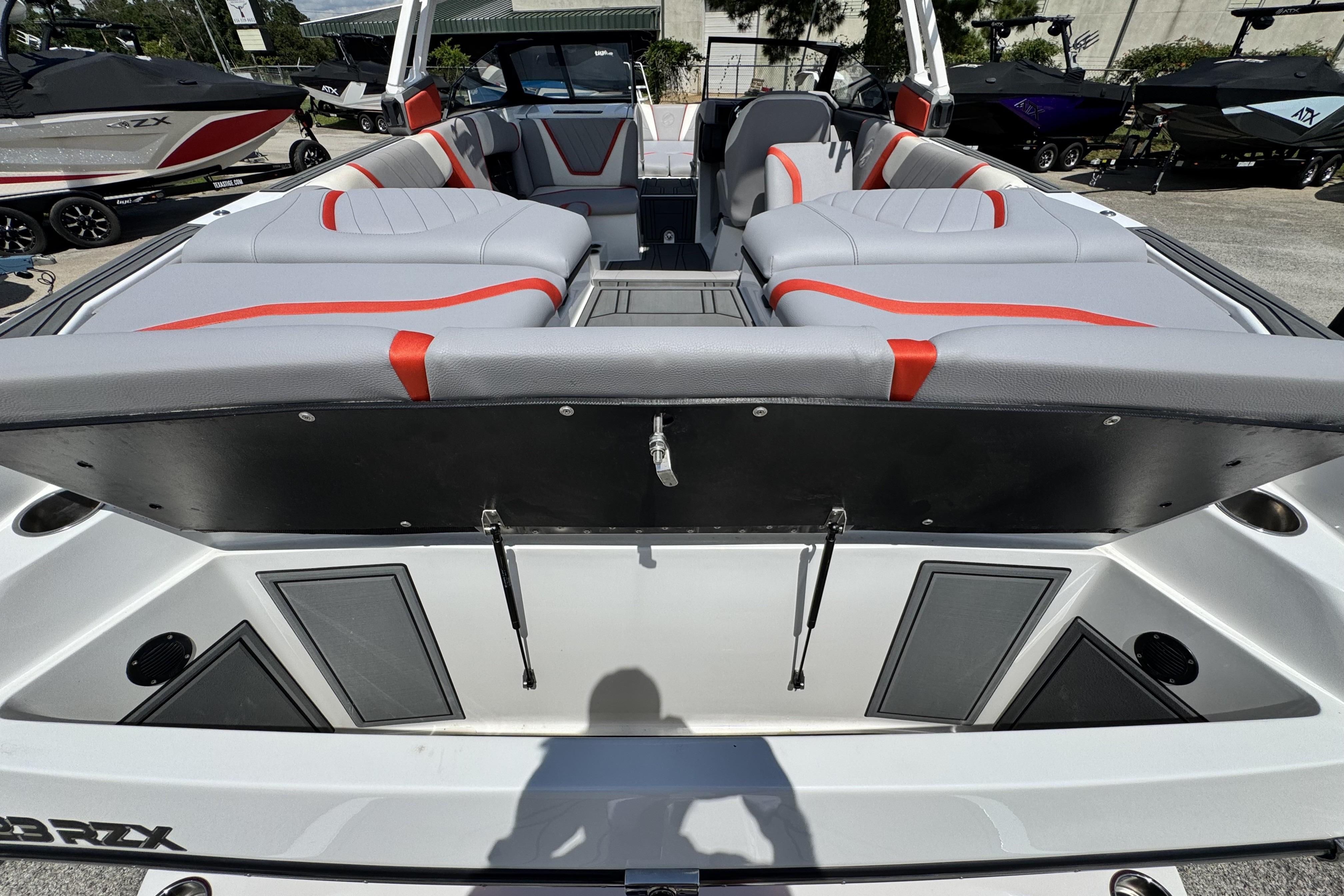 2021 Tigé 23RZX boat interior with gray and red seating, showcasing spacious design.