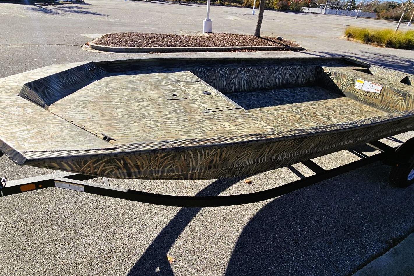 2025 Tracker Grizzly 1860 Utility boat with camouflage design on a trailer.