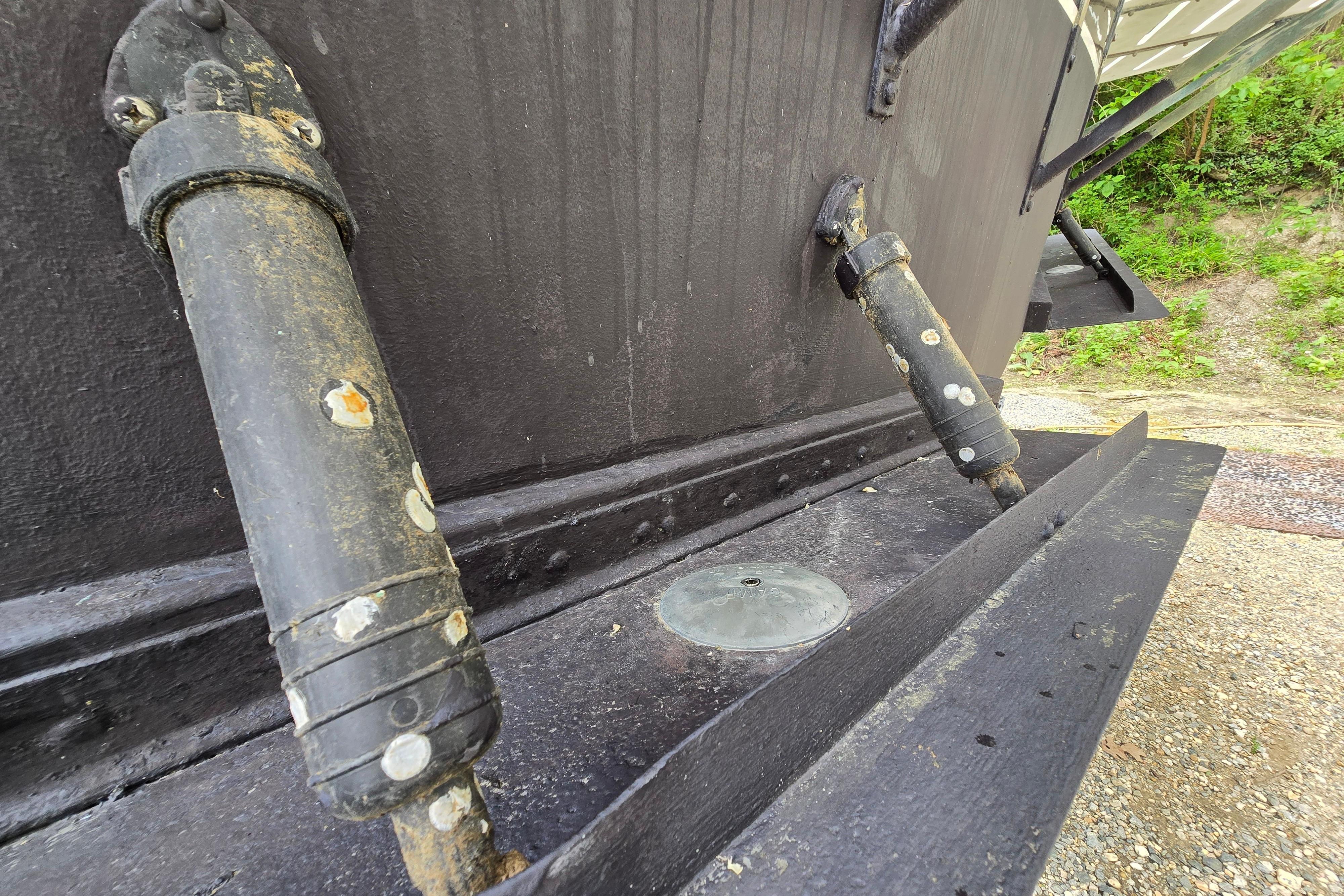 Close-up of 1980 Hatteras 70 Motor Yacht hull with hydraulic components.