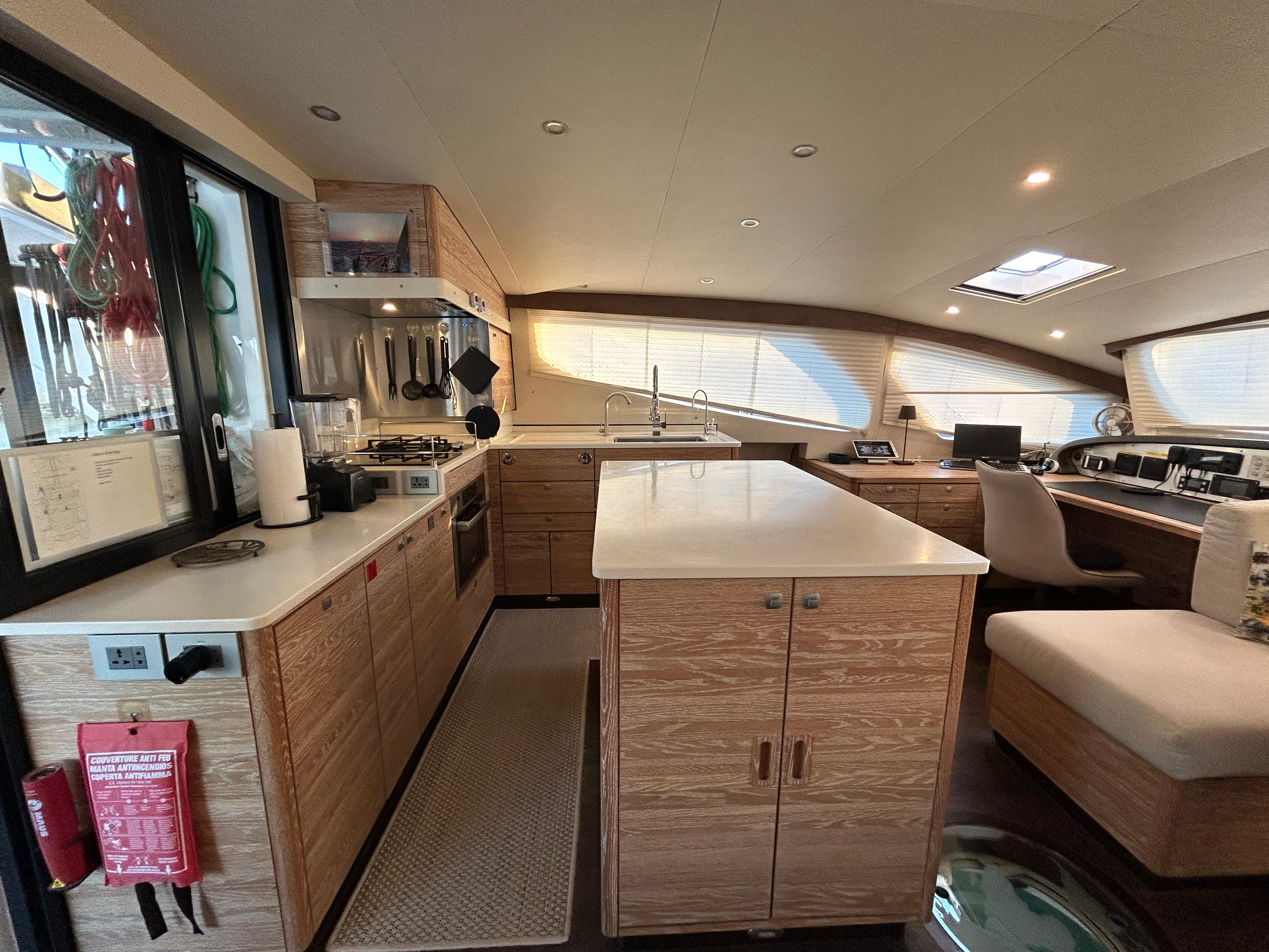 Luxurious 2019 Xquisite Yachts X5 interior with modern kitchen and seating area.